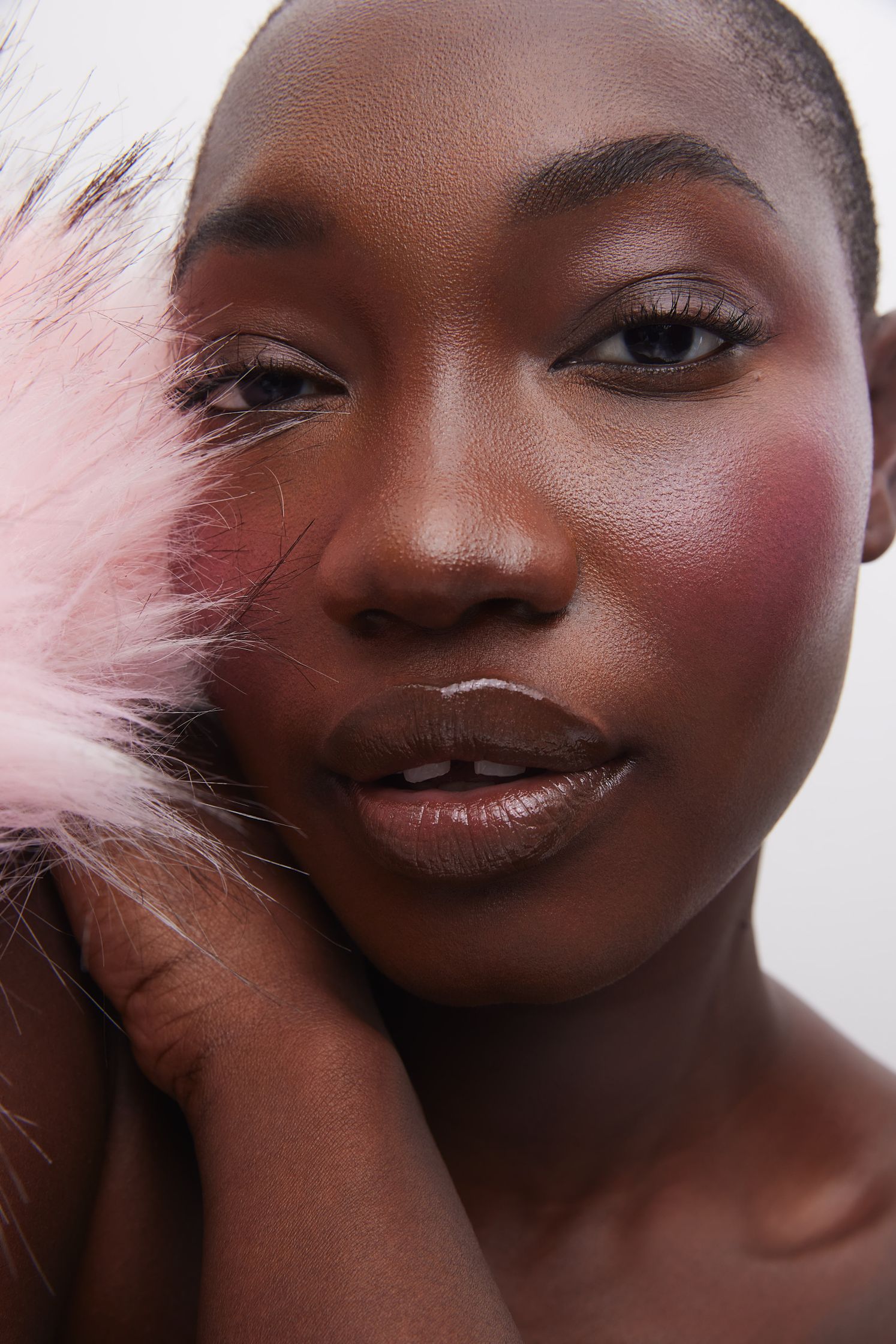 a black woman with a pink furry hat posing for a photo