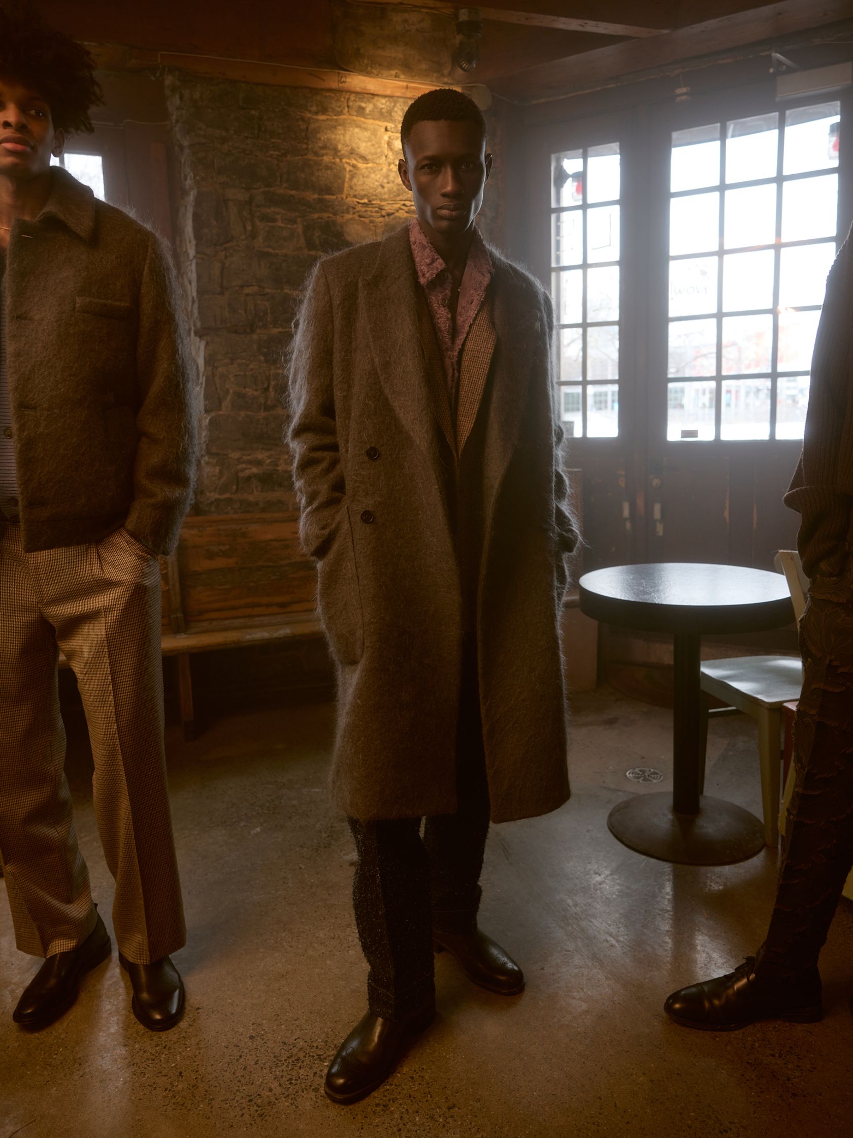 three men standing in a room