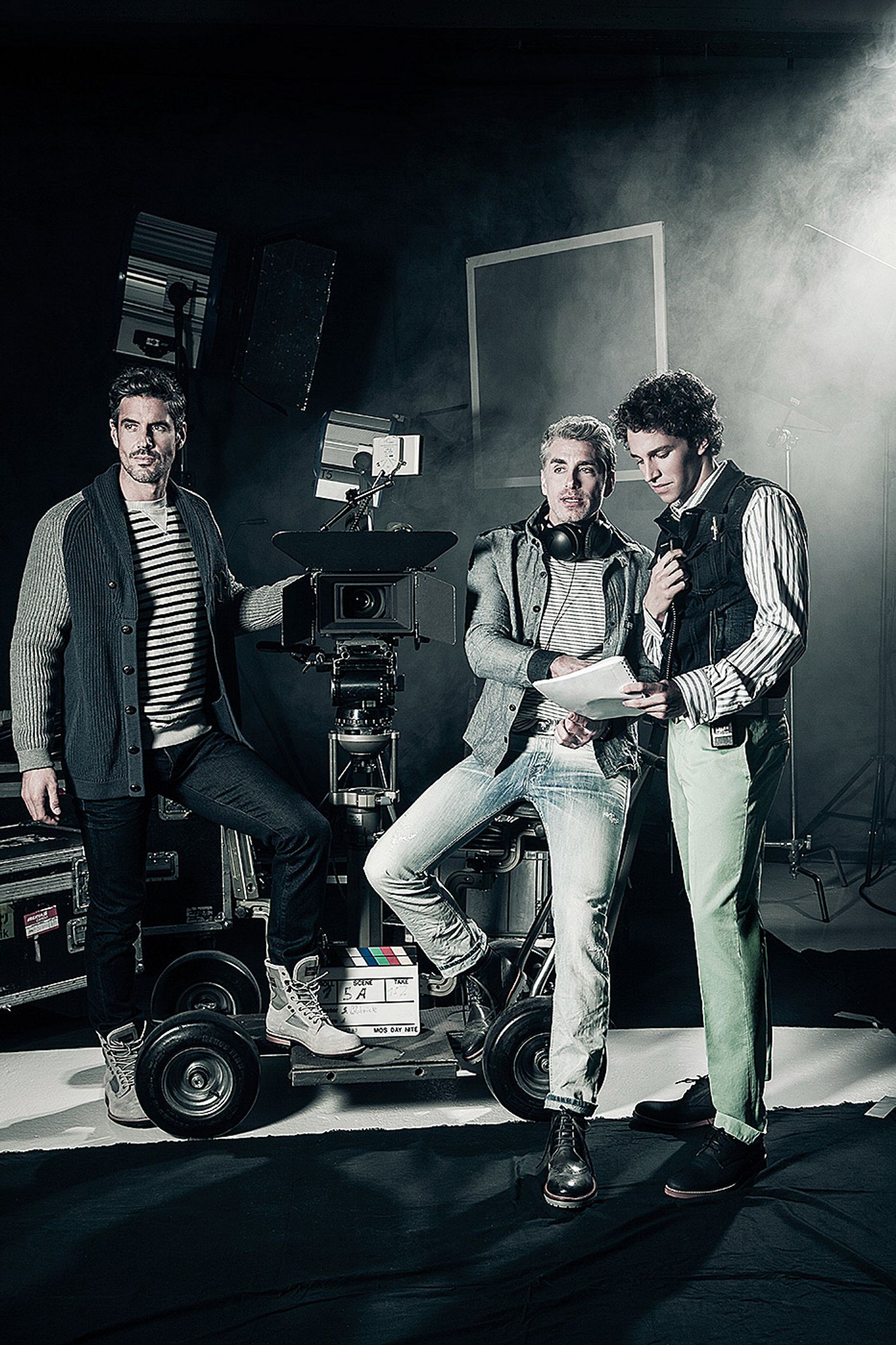 three men posing in front of a camera Post Production Hamburg