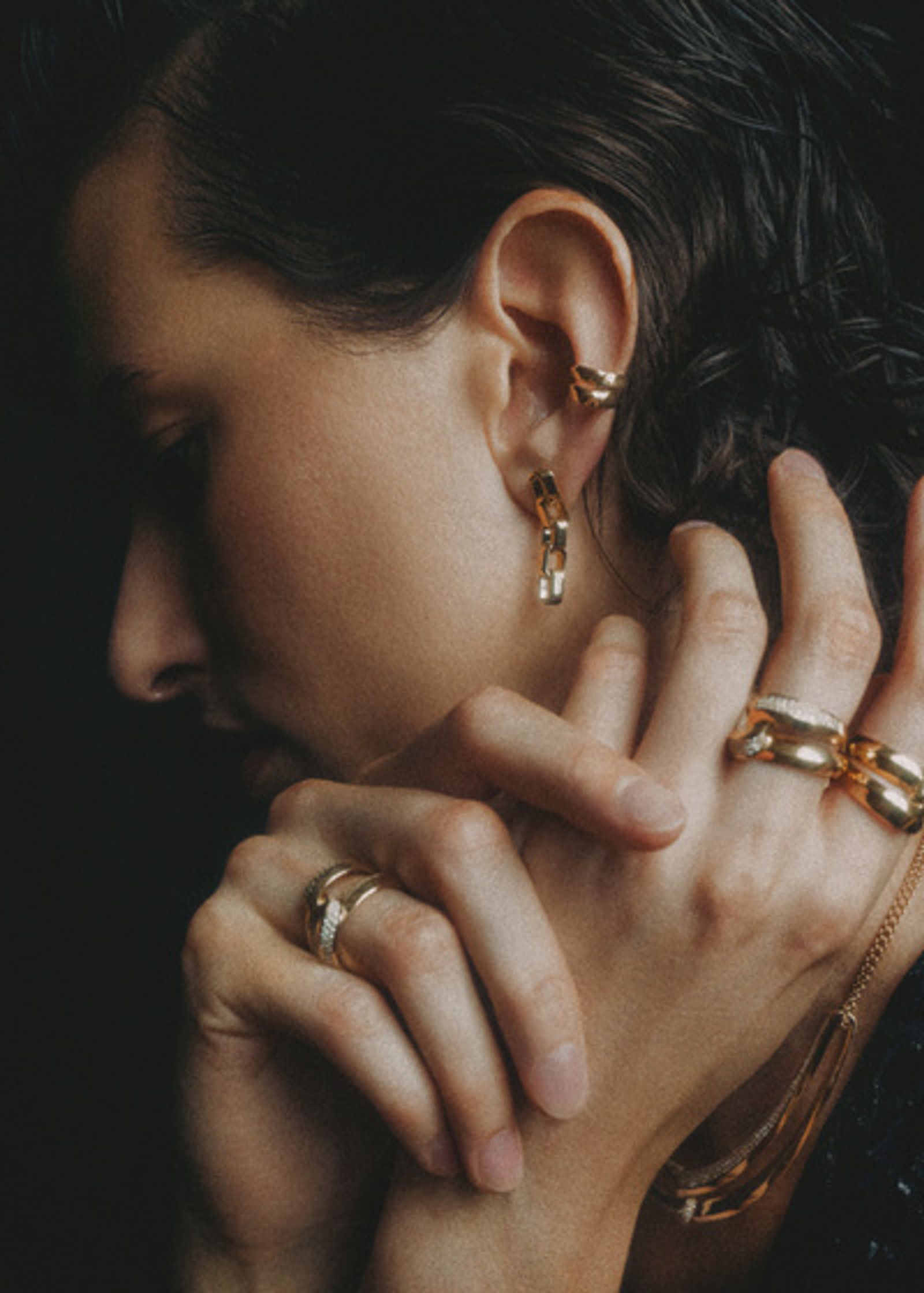 a woman wearing a gold ring on her hand