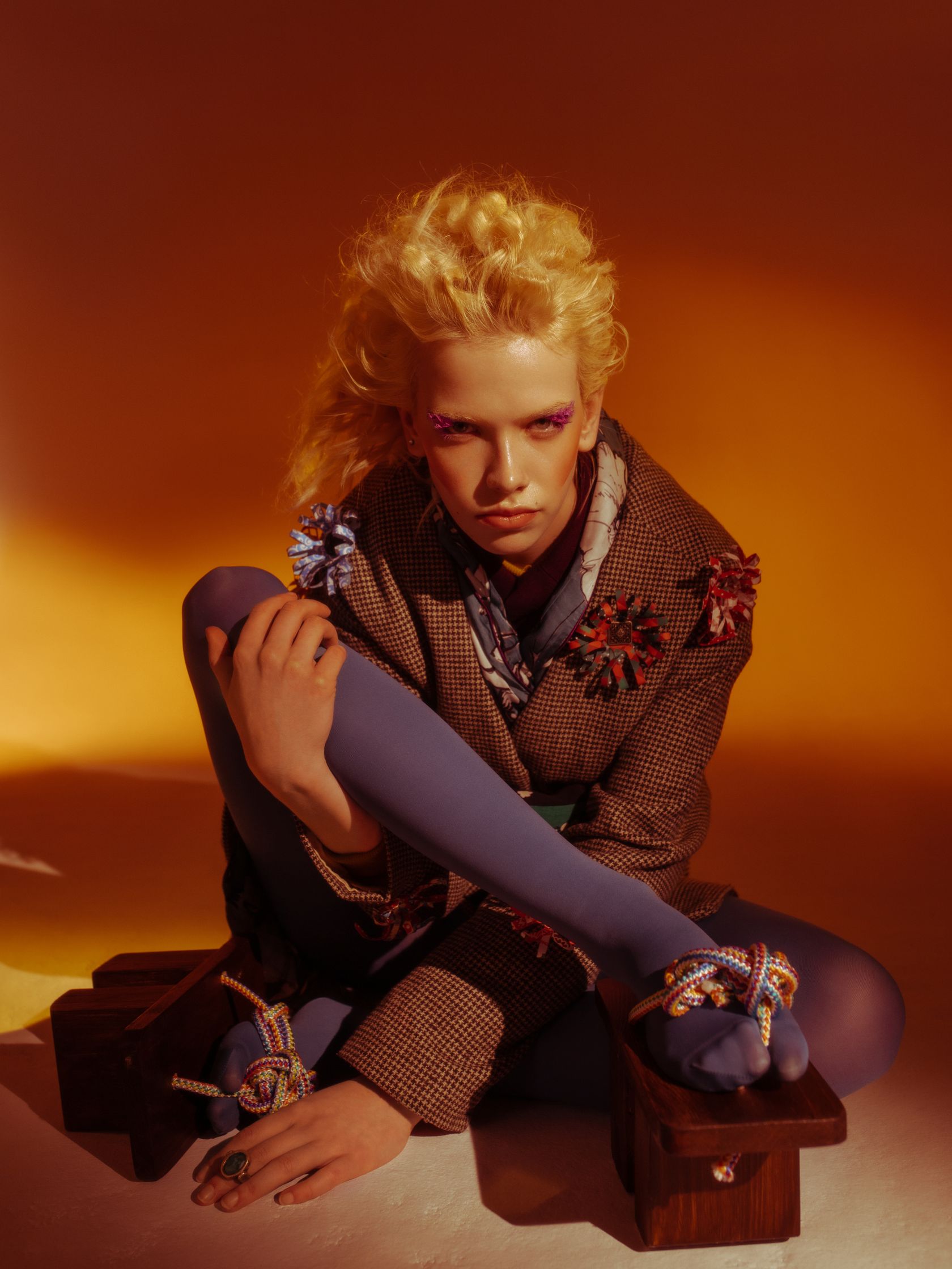 a woman is sitting on a wooden floor