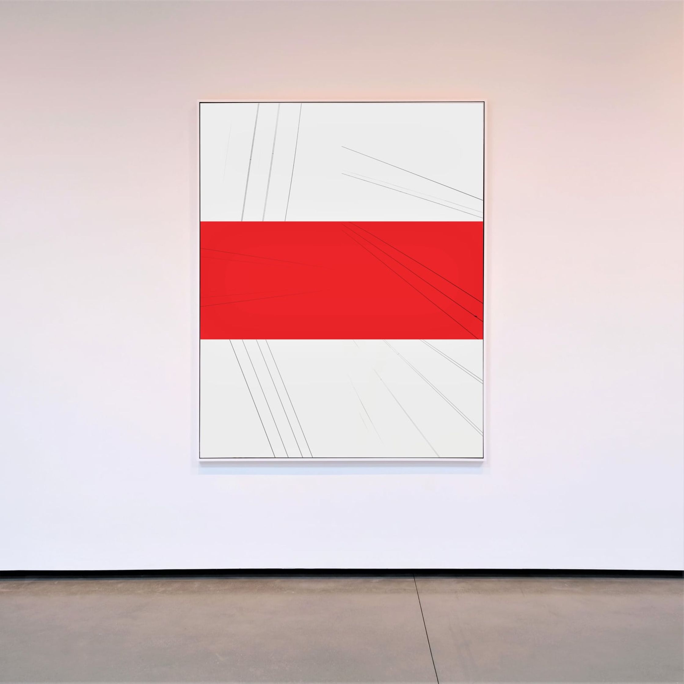 a red and white painting hangs on a white wall