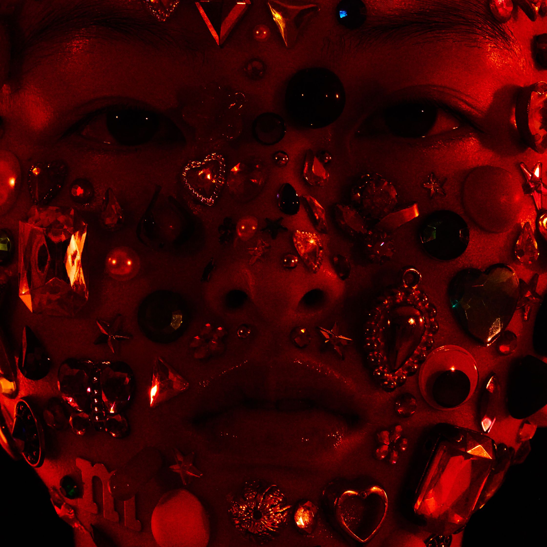 a person's face covered in jewels