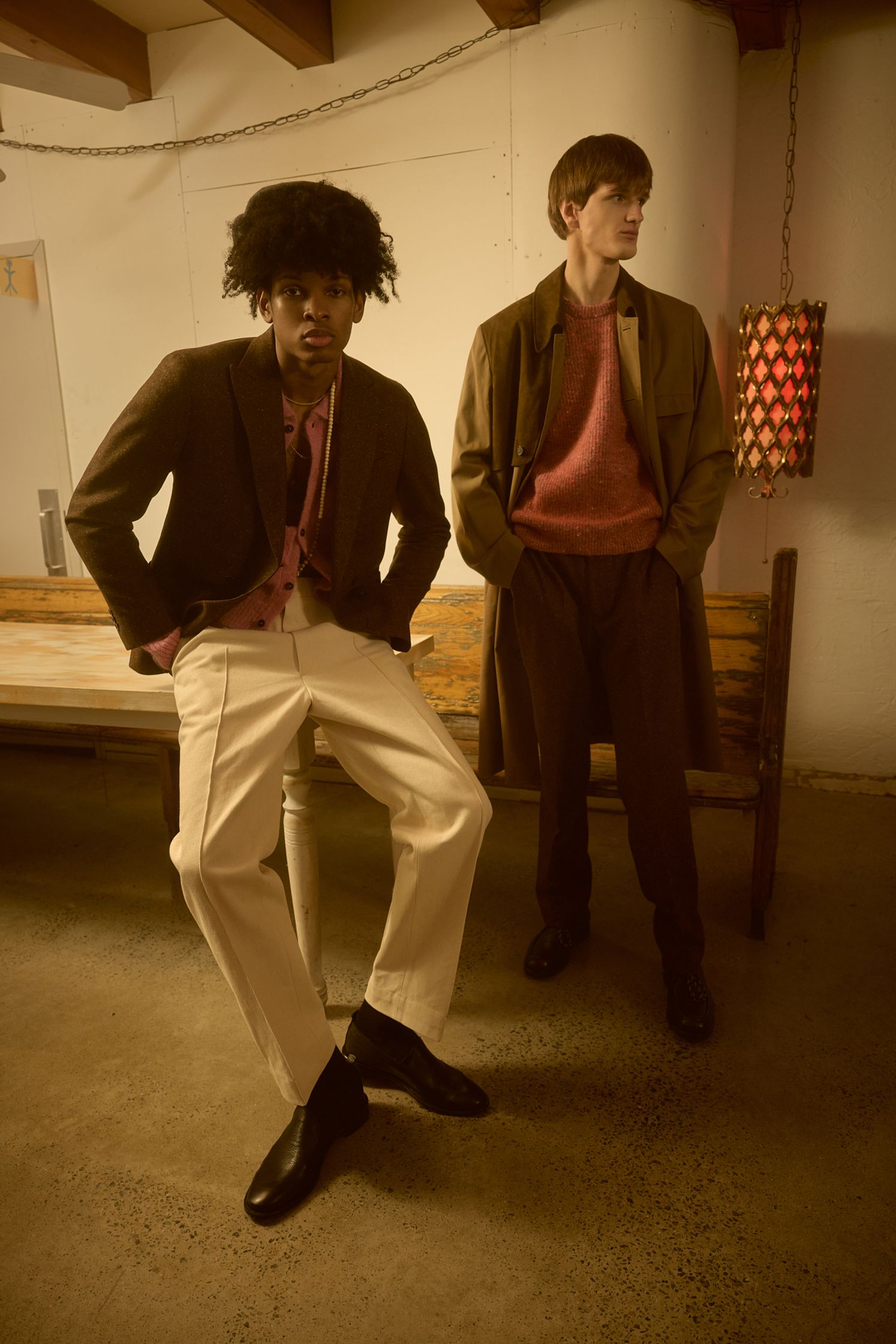 two men posing for a photo in a dark room