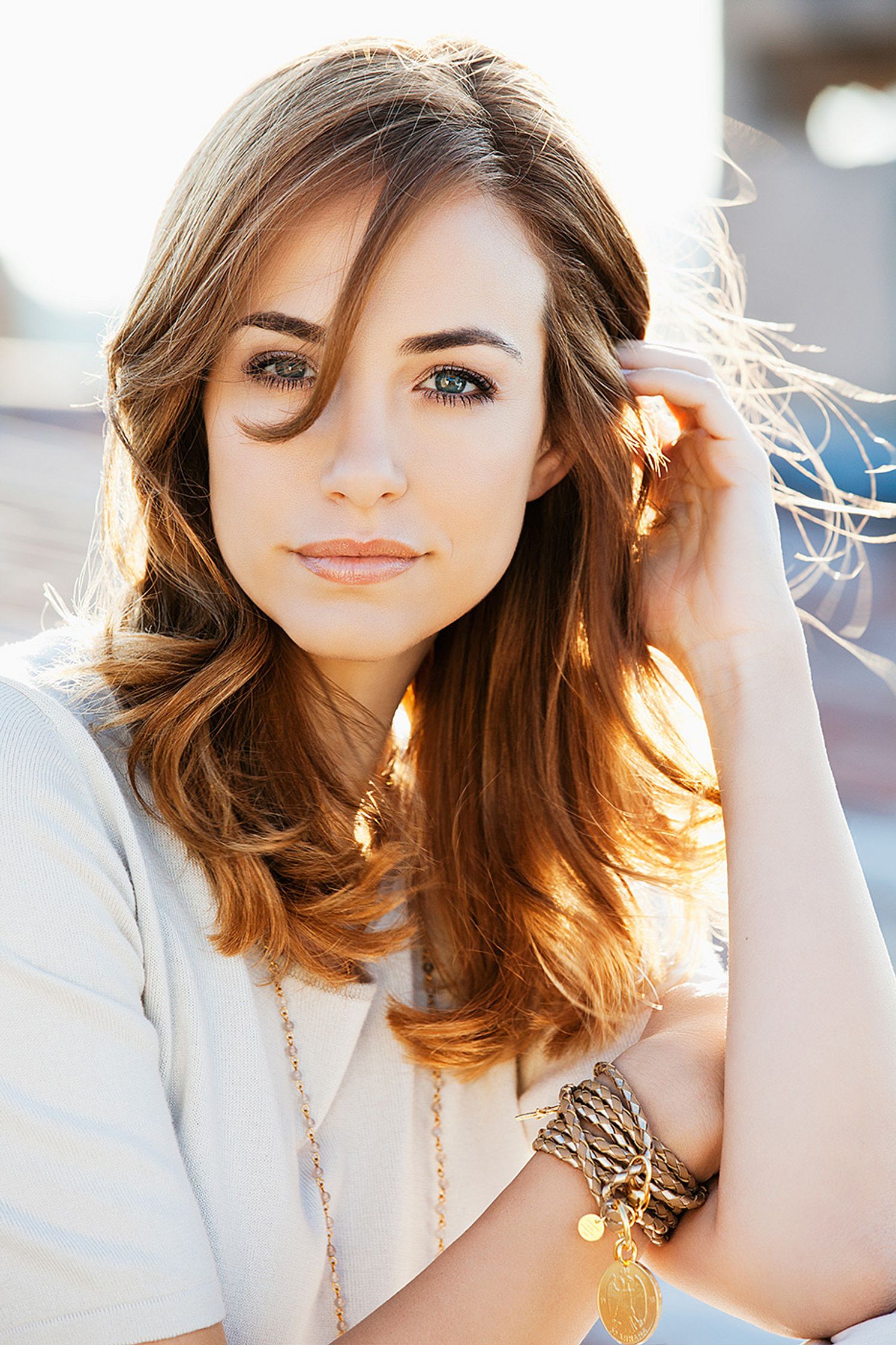 a woman with long brown hair posing for a picture retouch fashion campaign