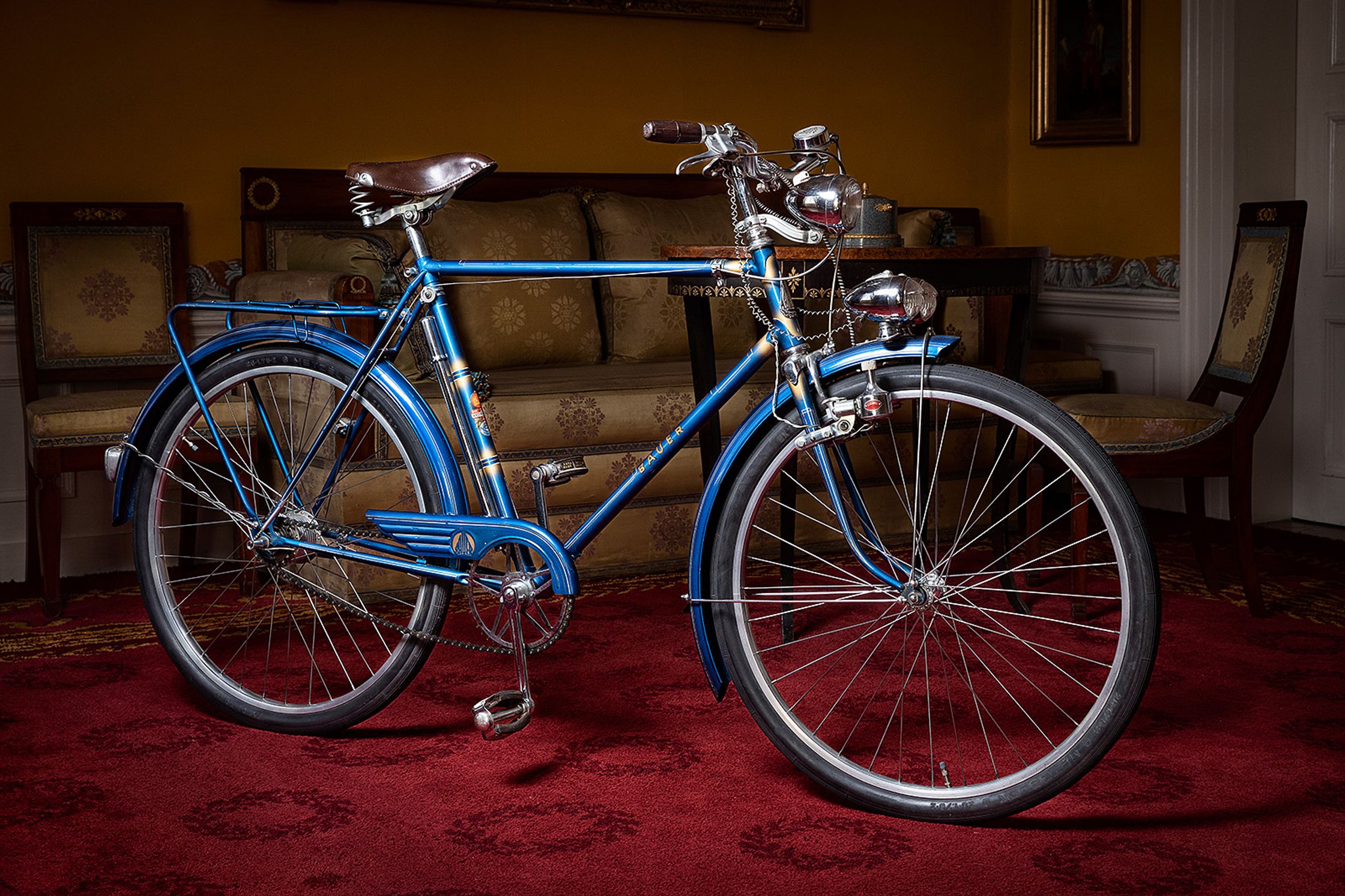 a blue bicycle parked on a red carpet product Post Production