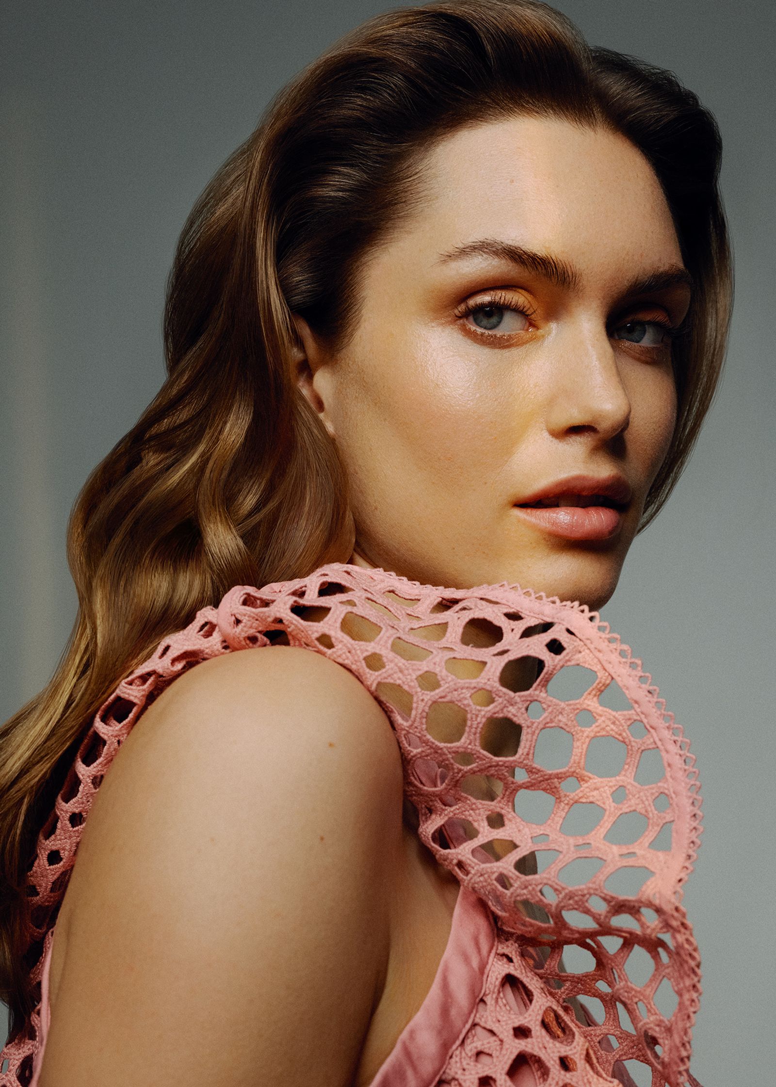 a woman in a pink dress posing for a photo