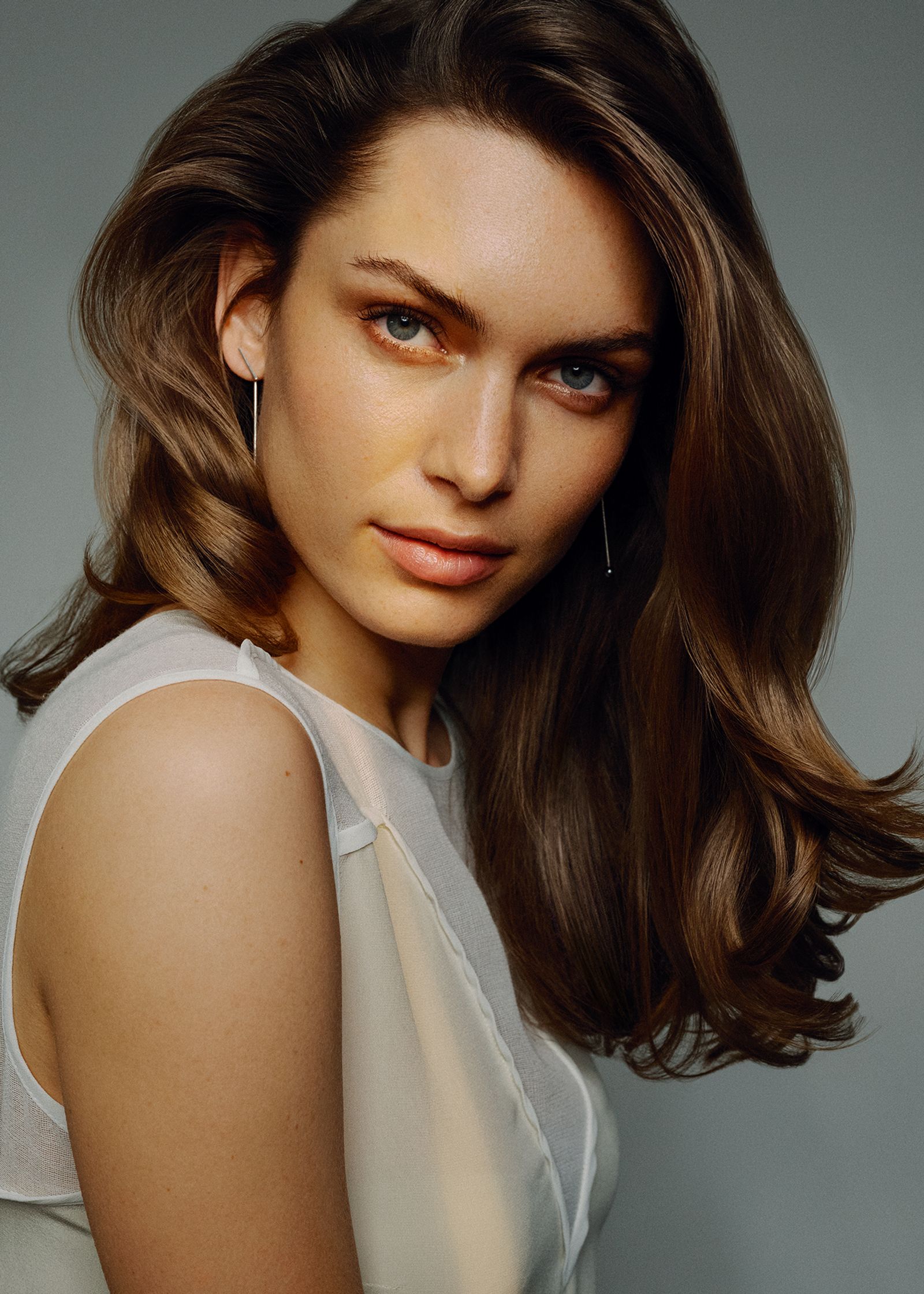 a woman with long brown hair posing for a photo