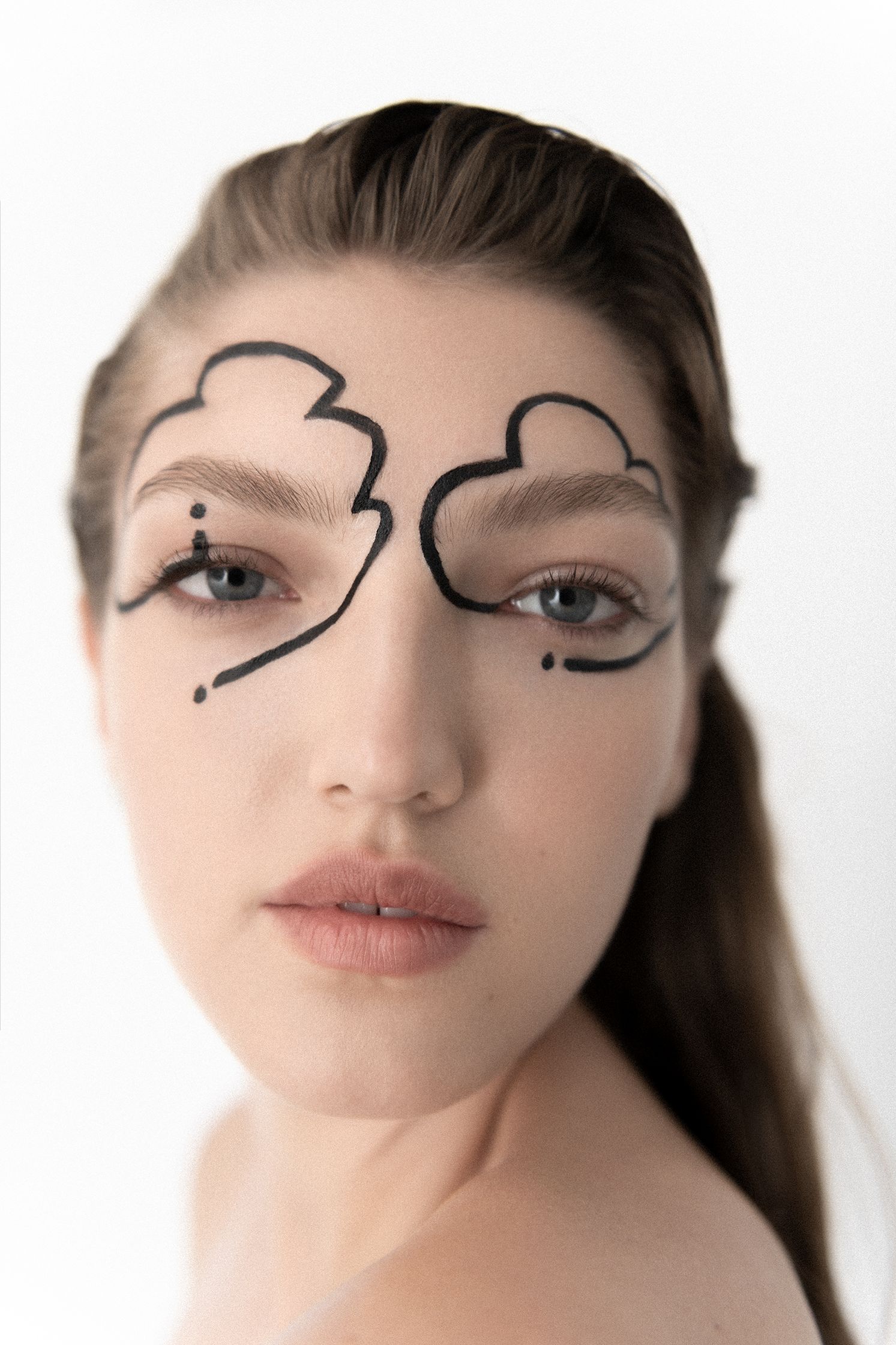 a woman with a black eyeliner on her face