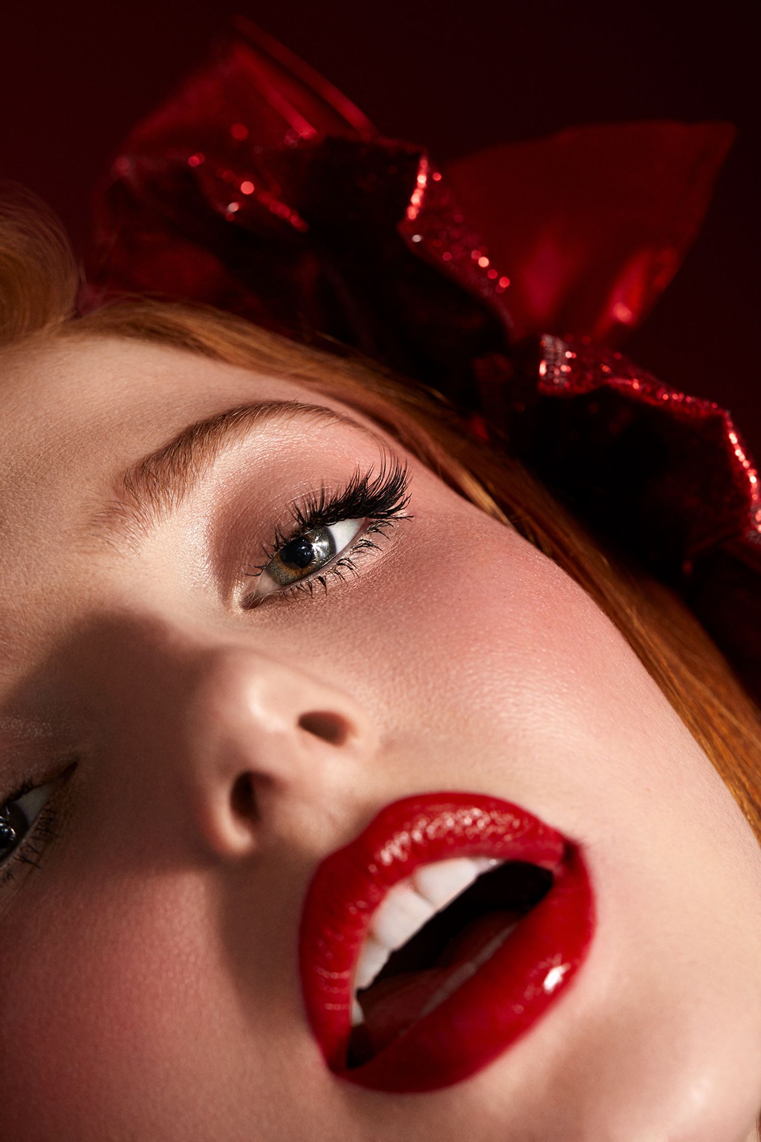 a woman with red lips and a bow on her head