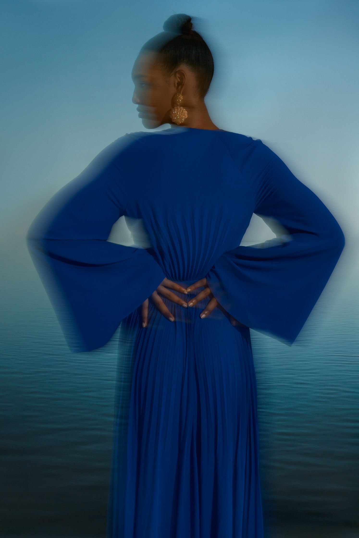 the back of a woman wearing a blue dress