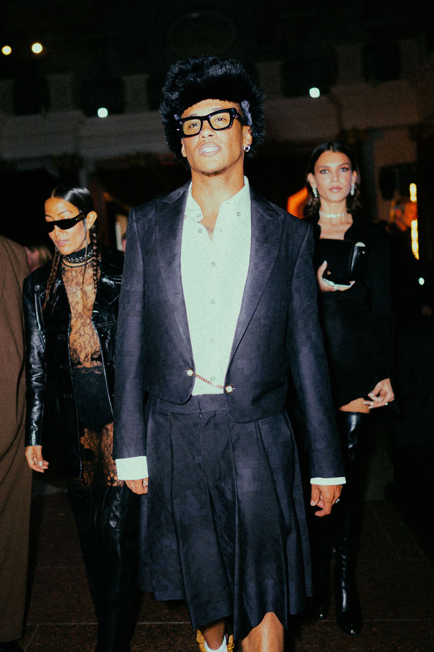 a man in a black suit walking down a runway Kelvyn Colt, Rapper