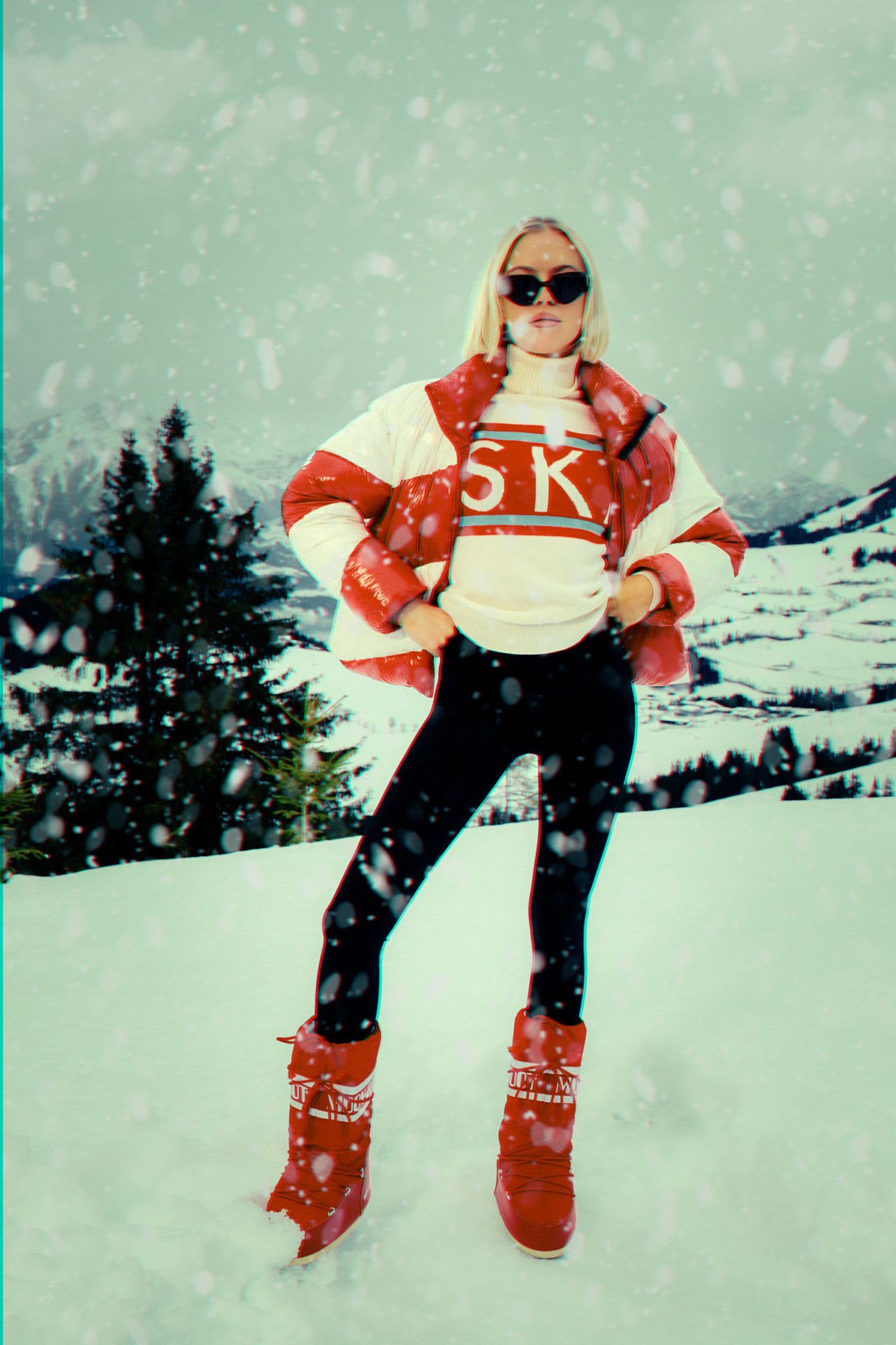 a woman in a red jacket posing in the snow