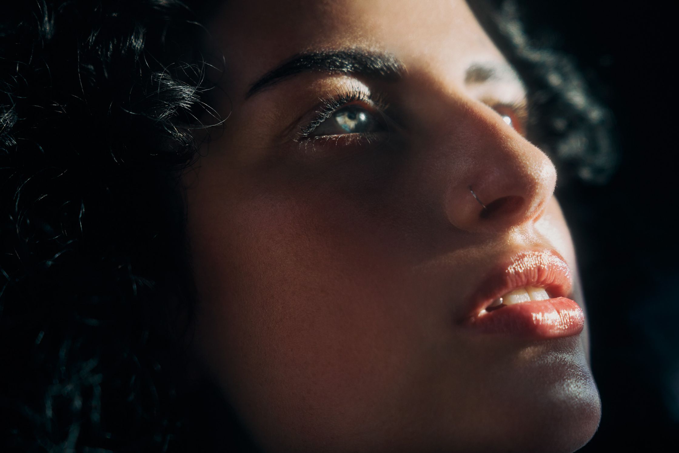 a close up of a woman with curly hair