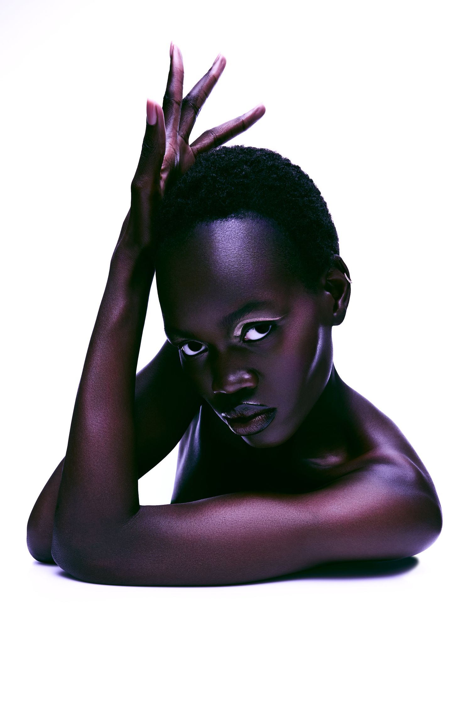 a black woman posing on a white background