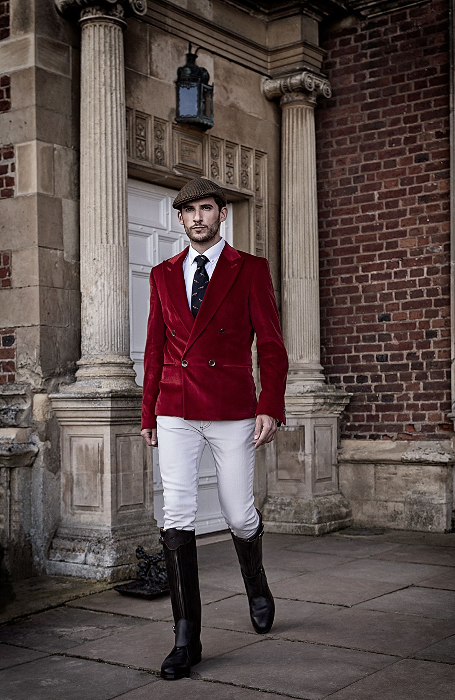 a man wearing a red jacket and white pants creative post production