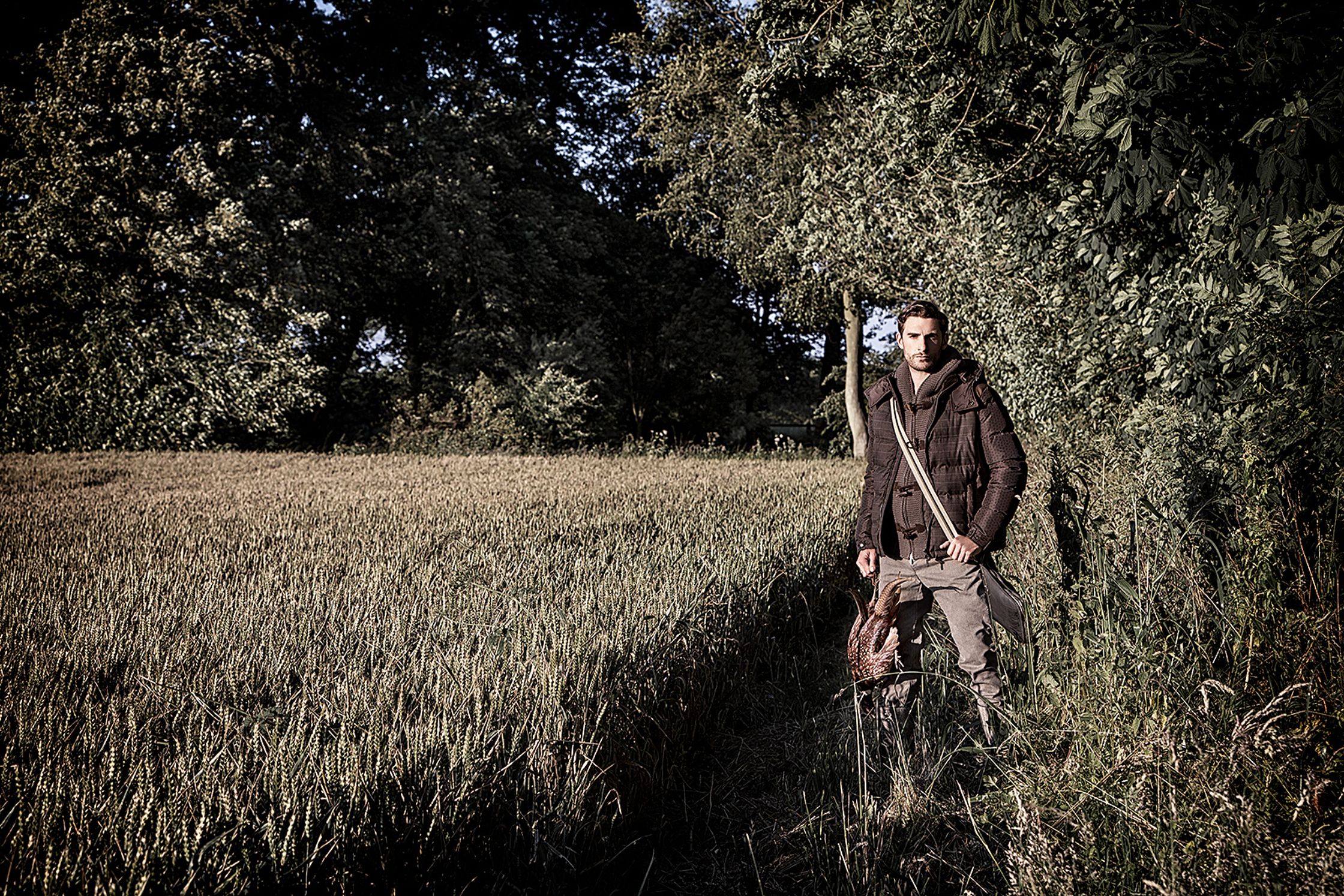 a man standing in the middle of a field creative post production