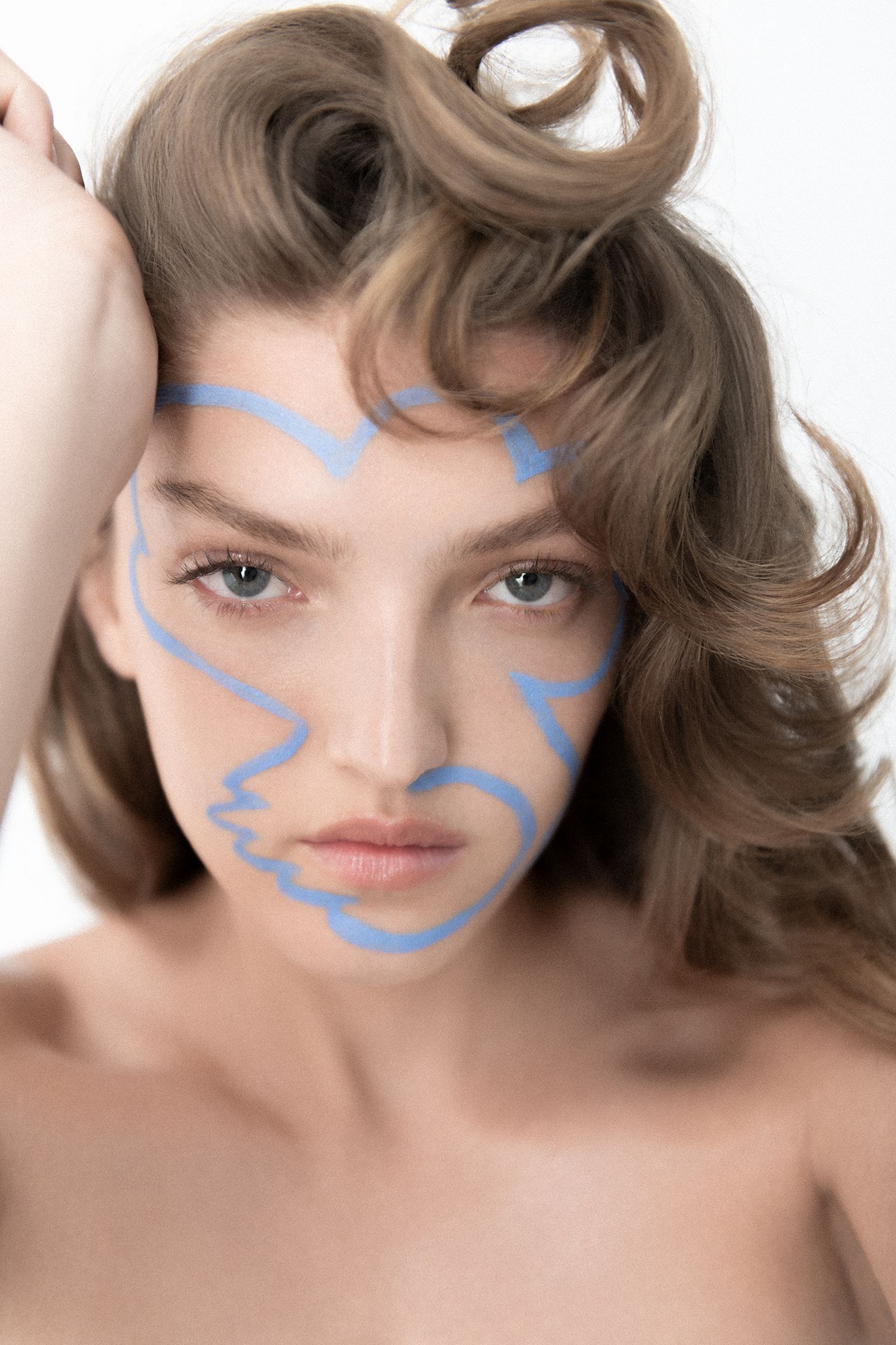 a woman with blue paint on her face