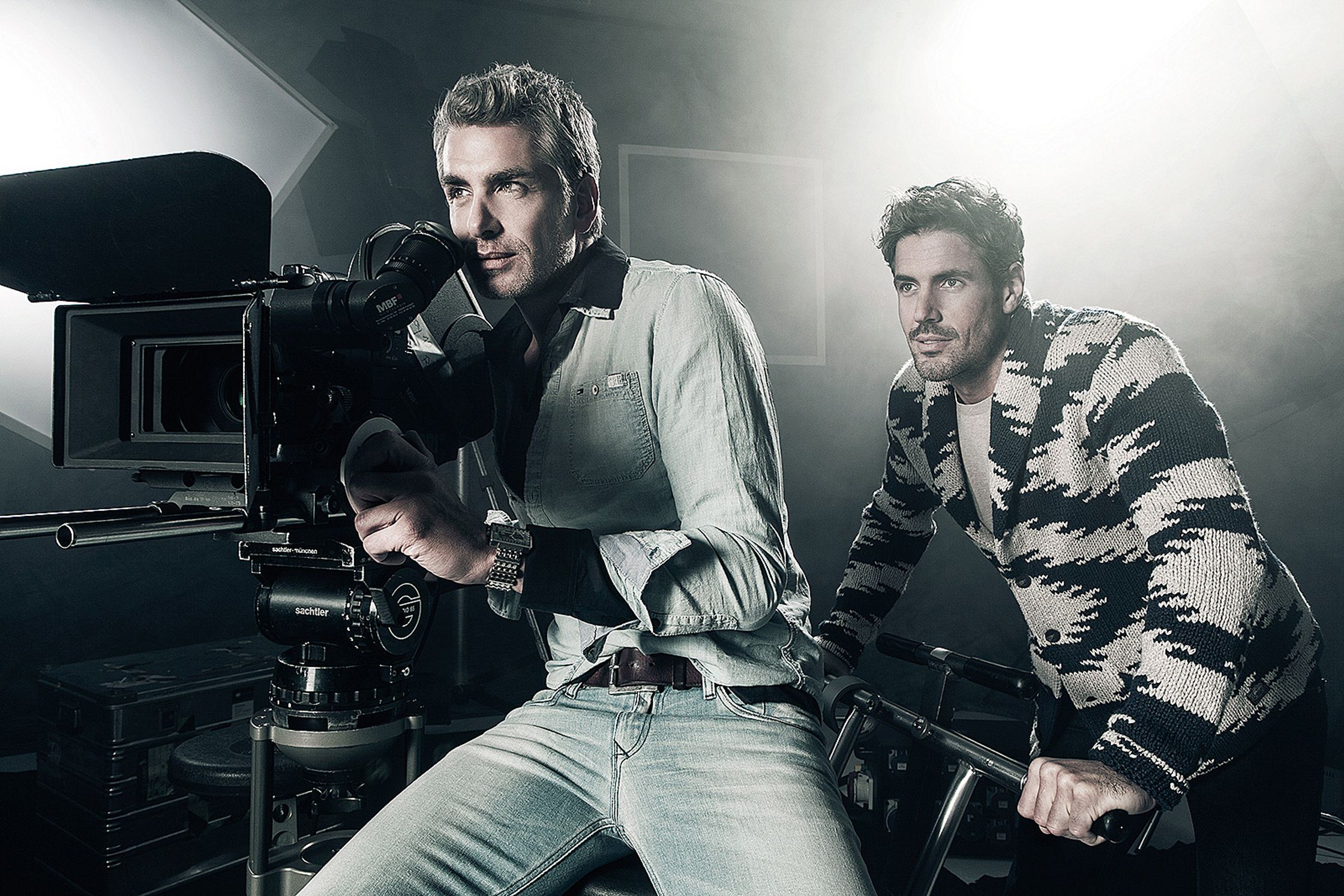 two men posing in front of a camera Post Production Hamburg