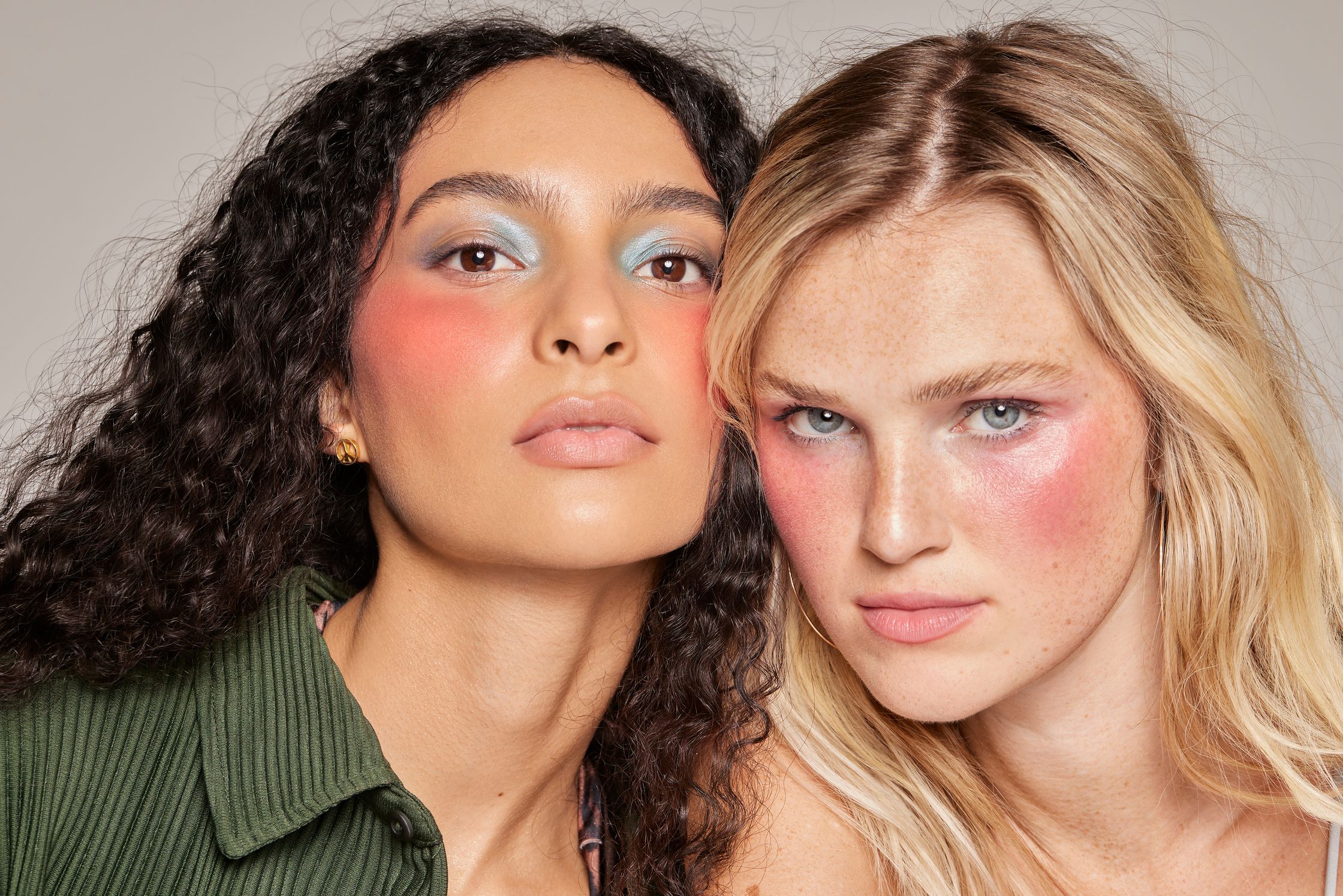 two women are posing for a photo with colorful makeup