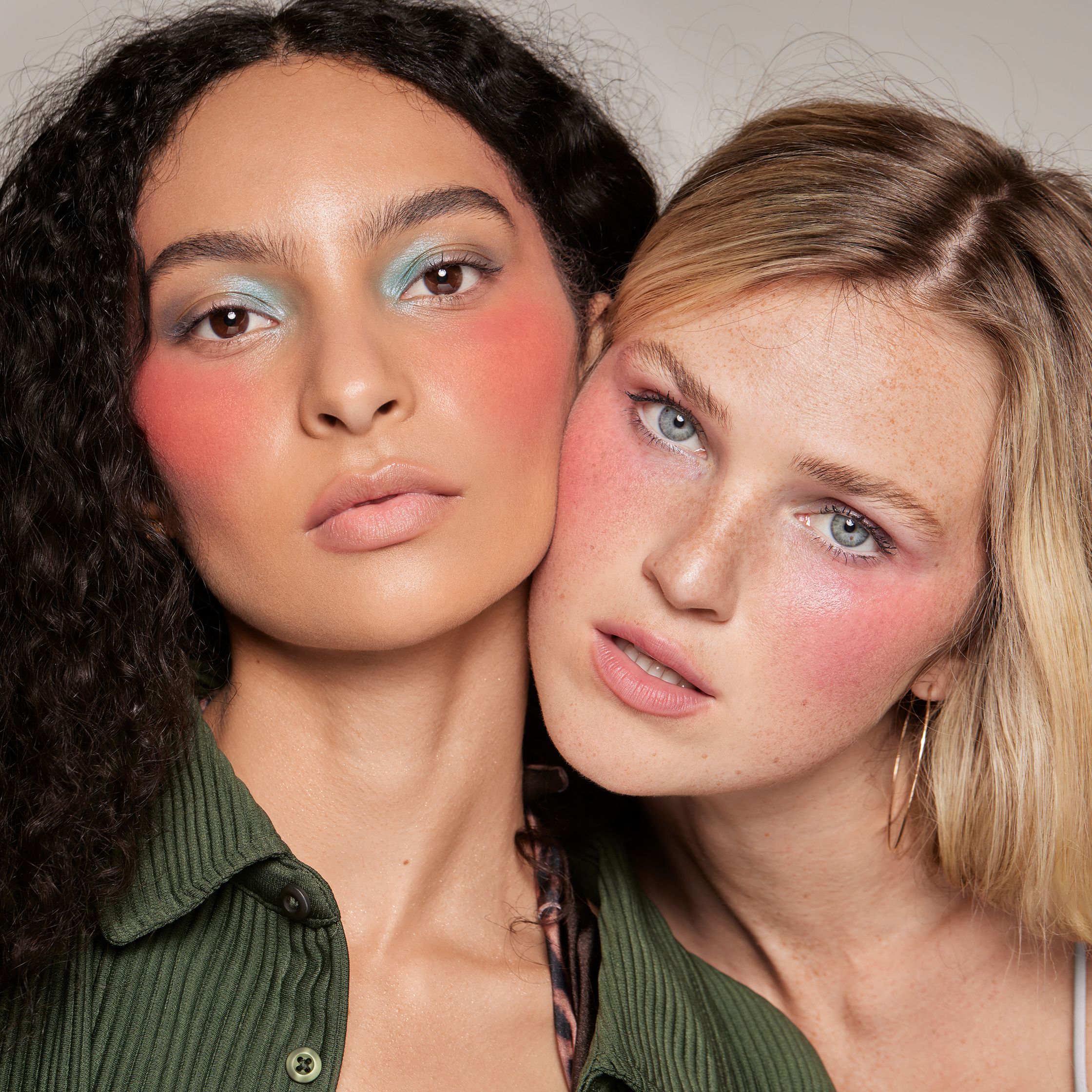 two women are posing for a photo with colorful makeup