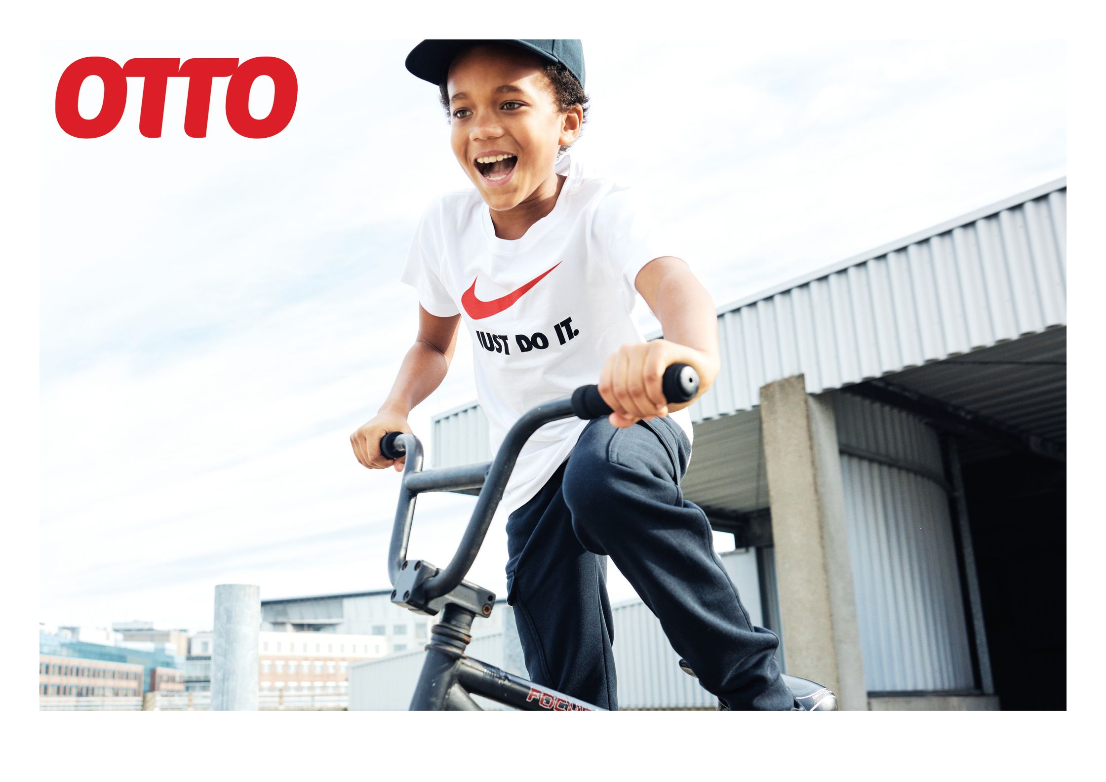 a young boy riding a bike with the words otto