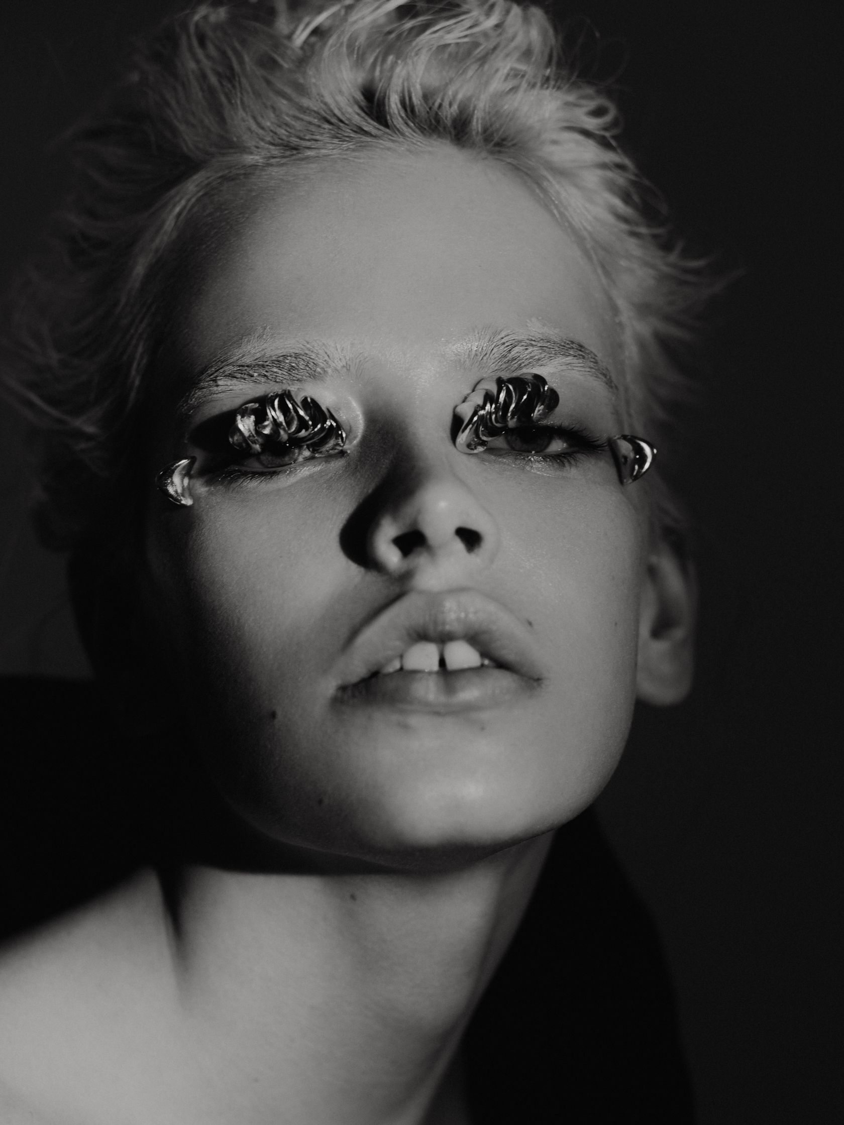 a black and white photo of a woman with fake eyelashes