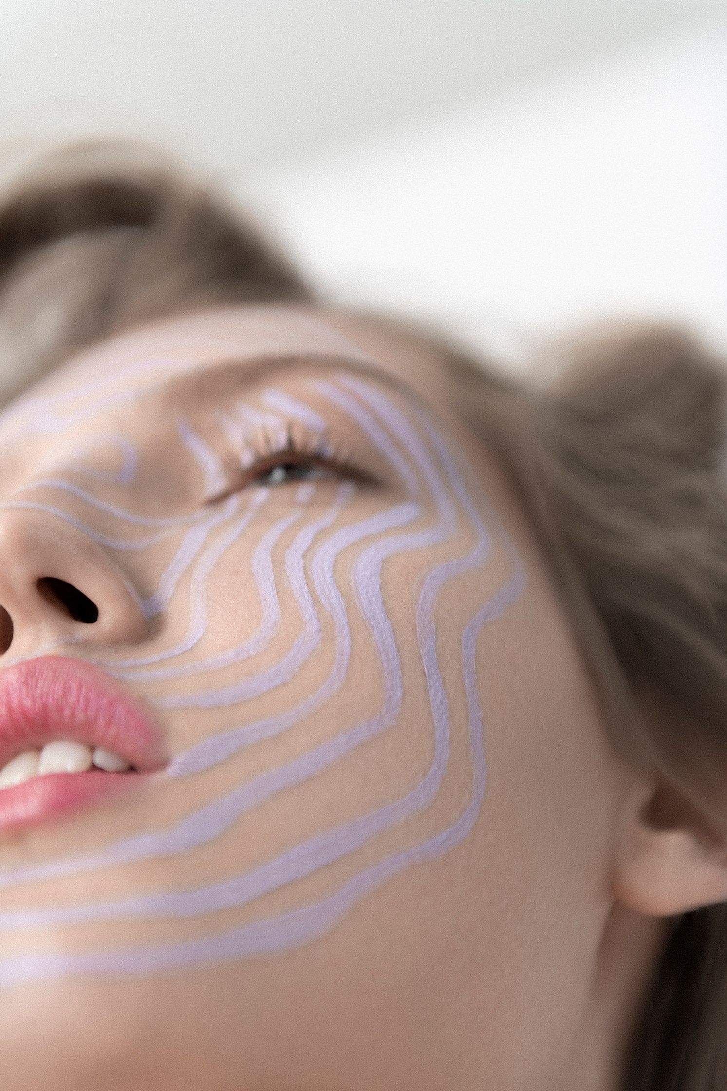 a woman's face with a pattern painted on it