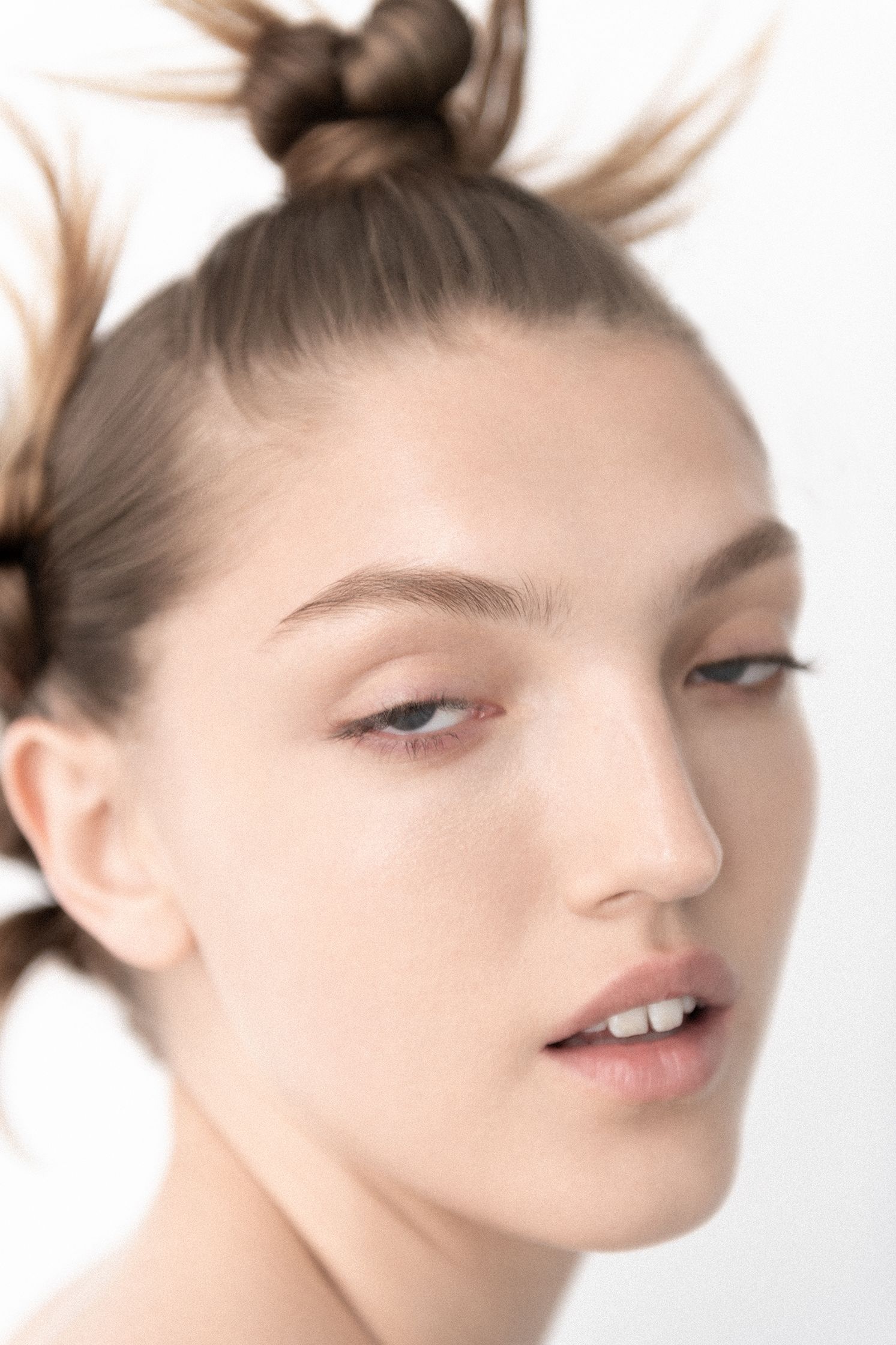 a woman with her hair up in a bun