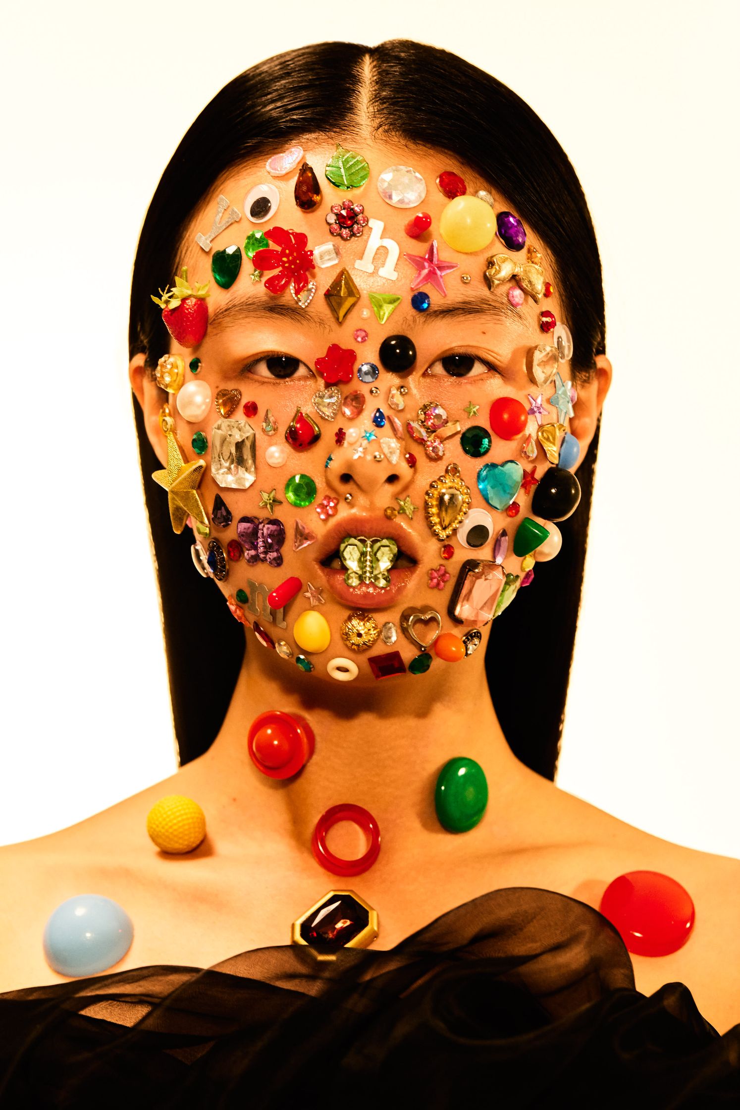 a woman's face covered with a lot of jewels