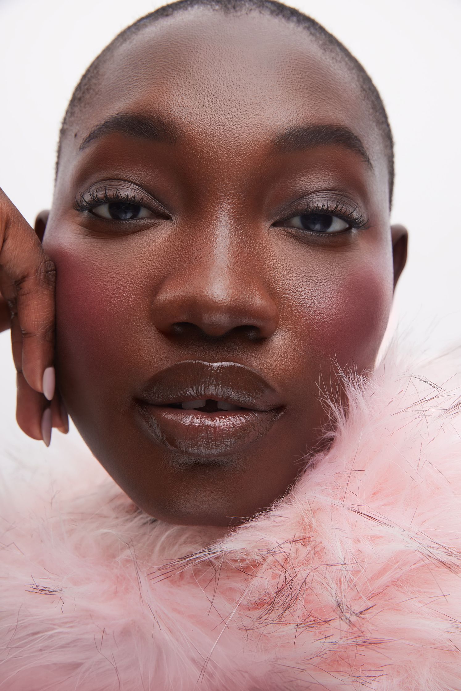 a black woman in a pink fur coat posing for a photo