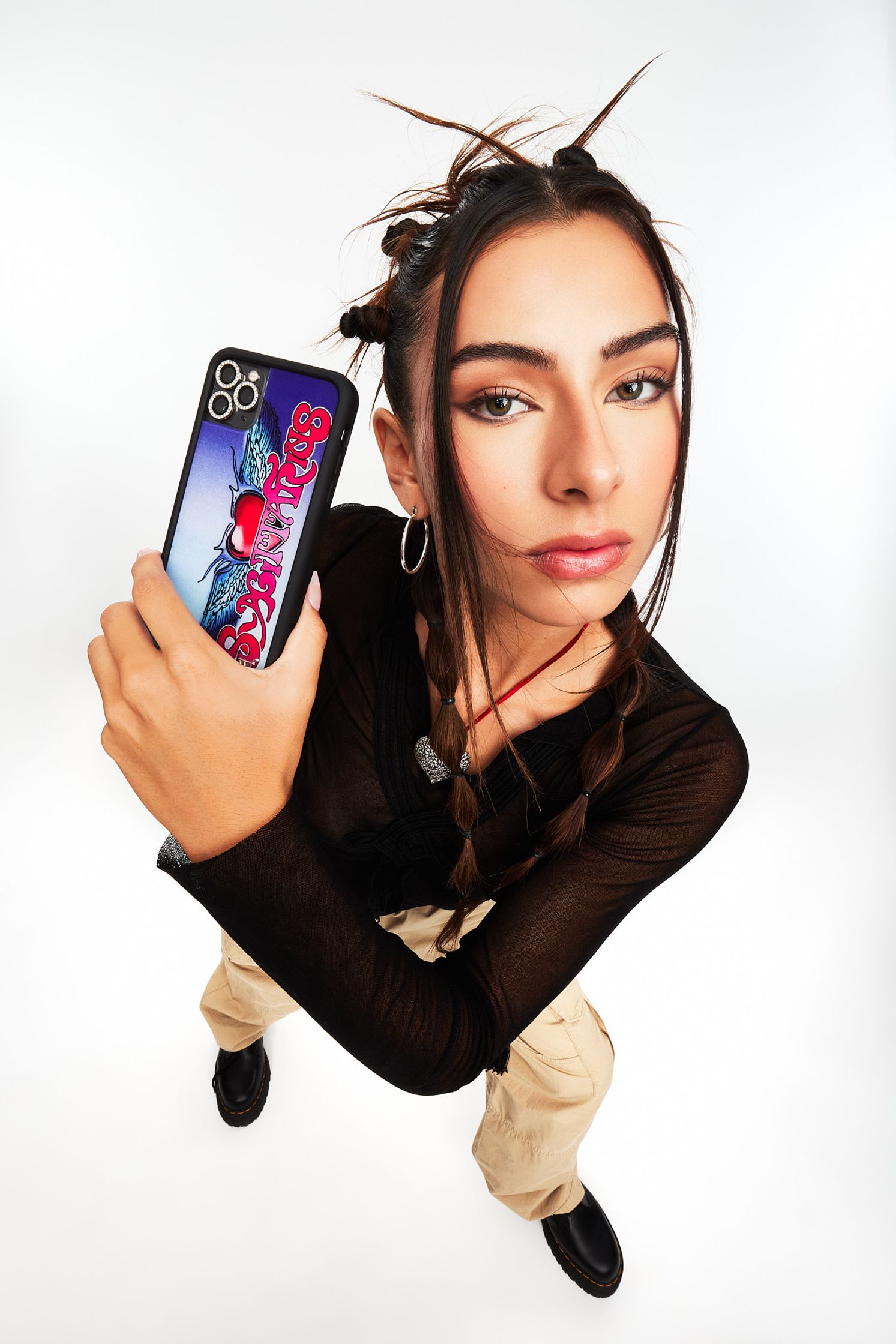 a woman holding up a cell phone