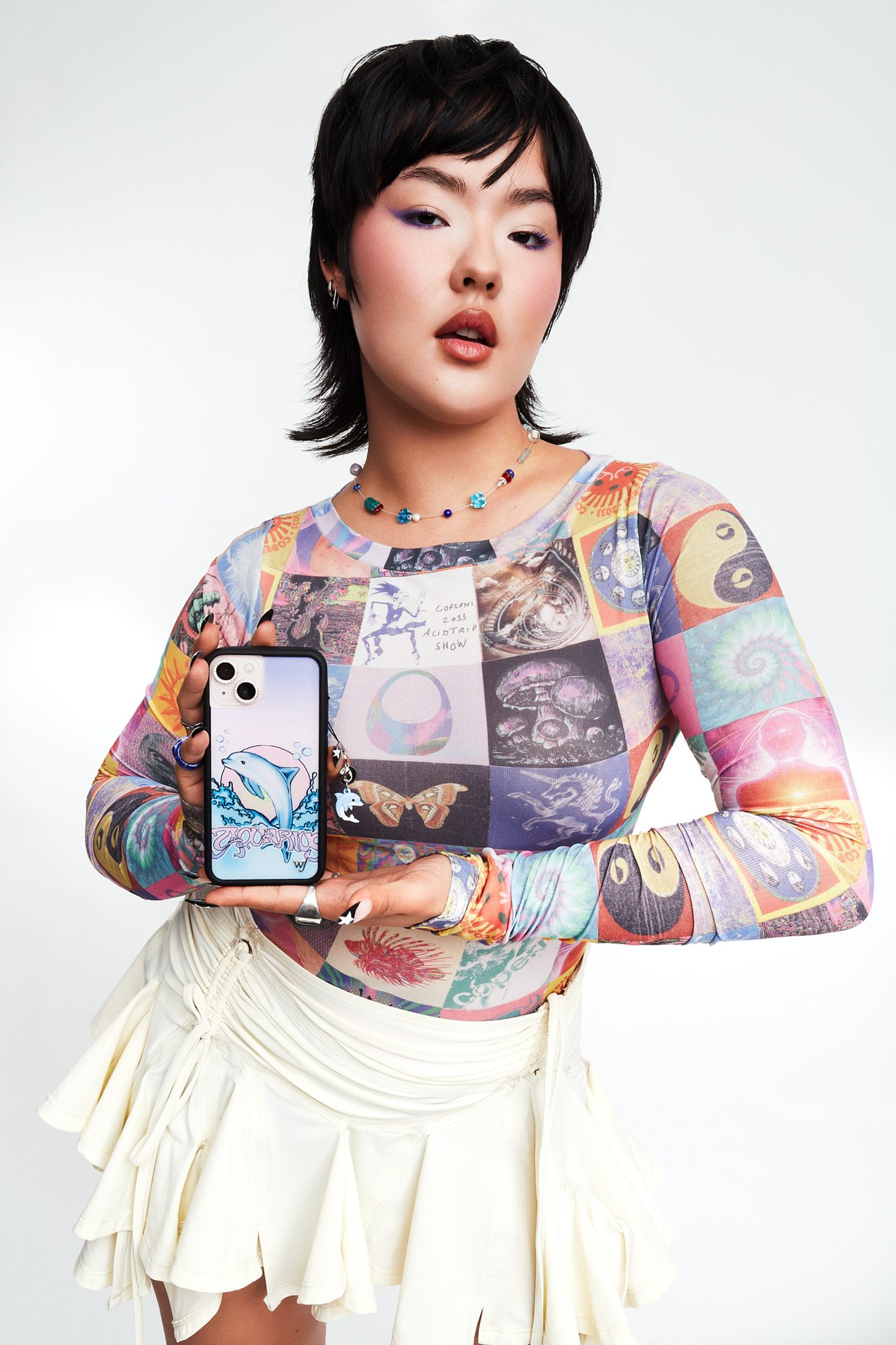 a woman in a white shirt holding a phone