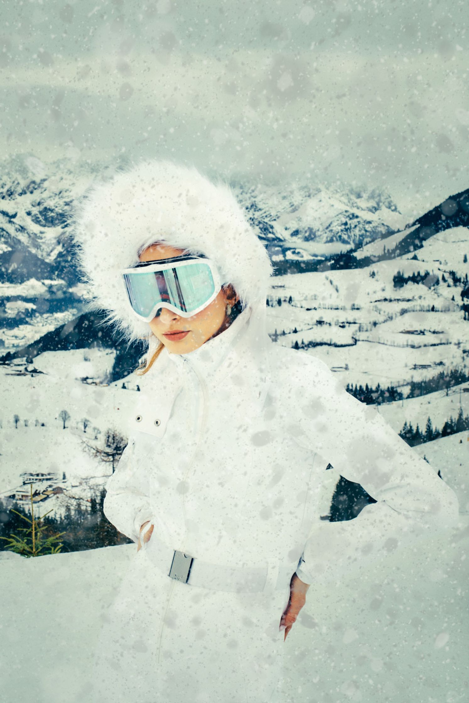 a woman wearing ski goggles on a snowy mountain