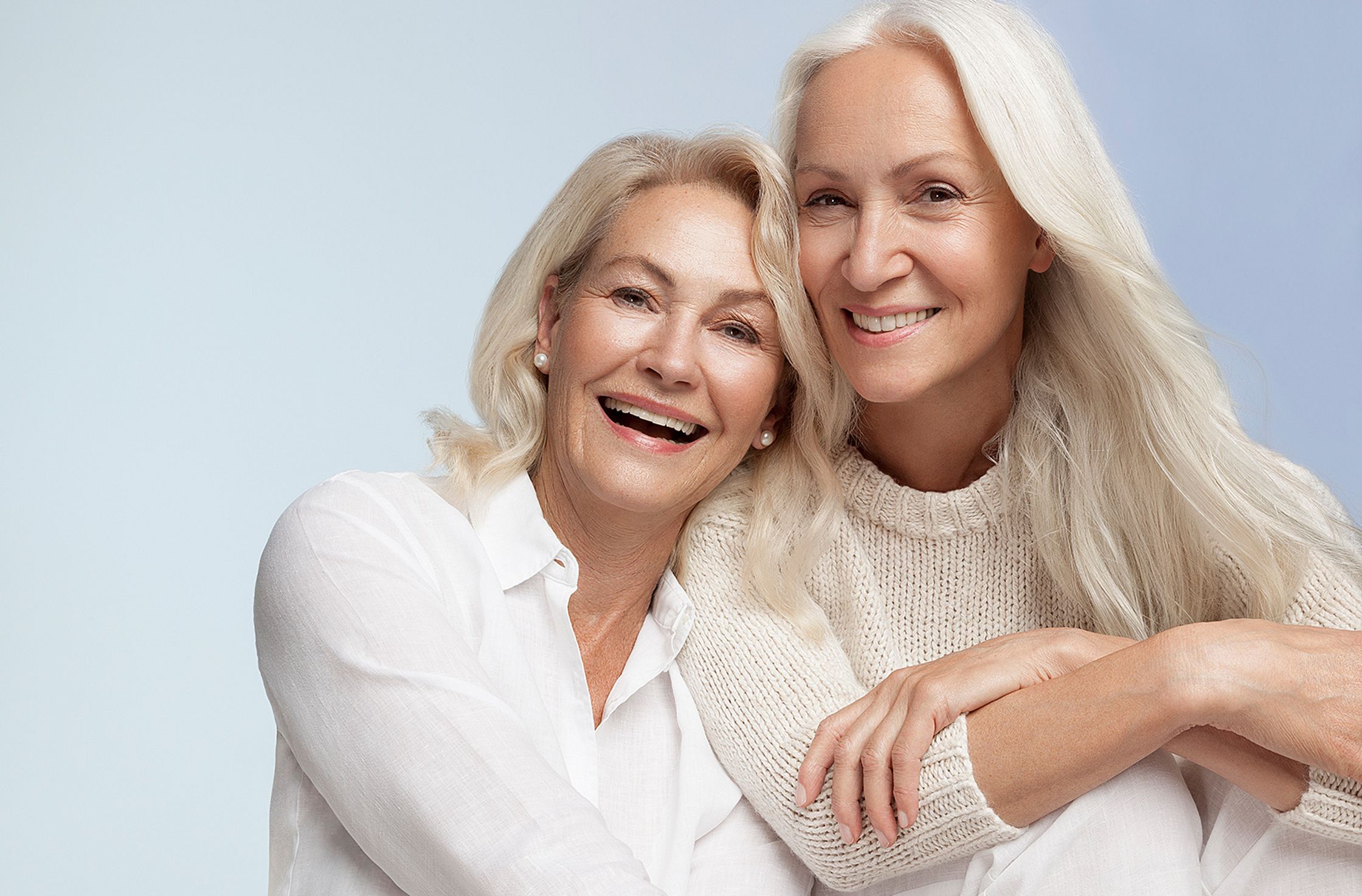 two elderly women posing for a photo best ager post production