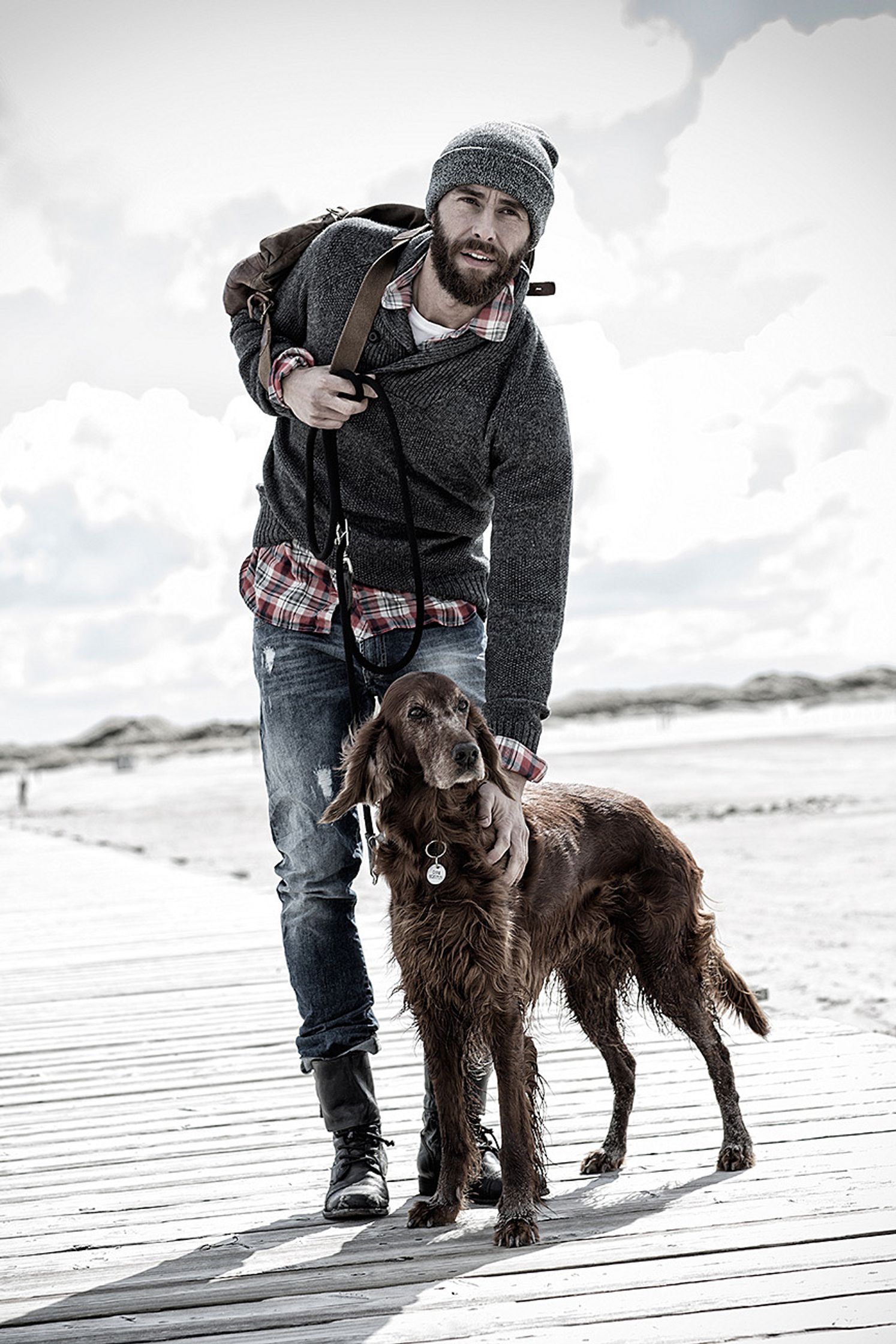 a man with a dog on a boardwalk post production clothes campaign