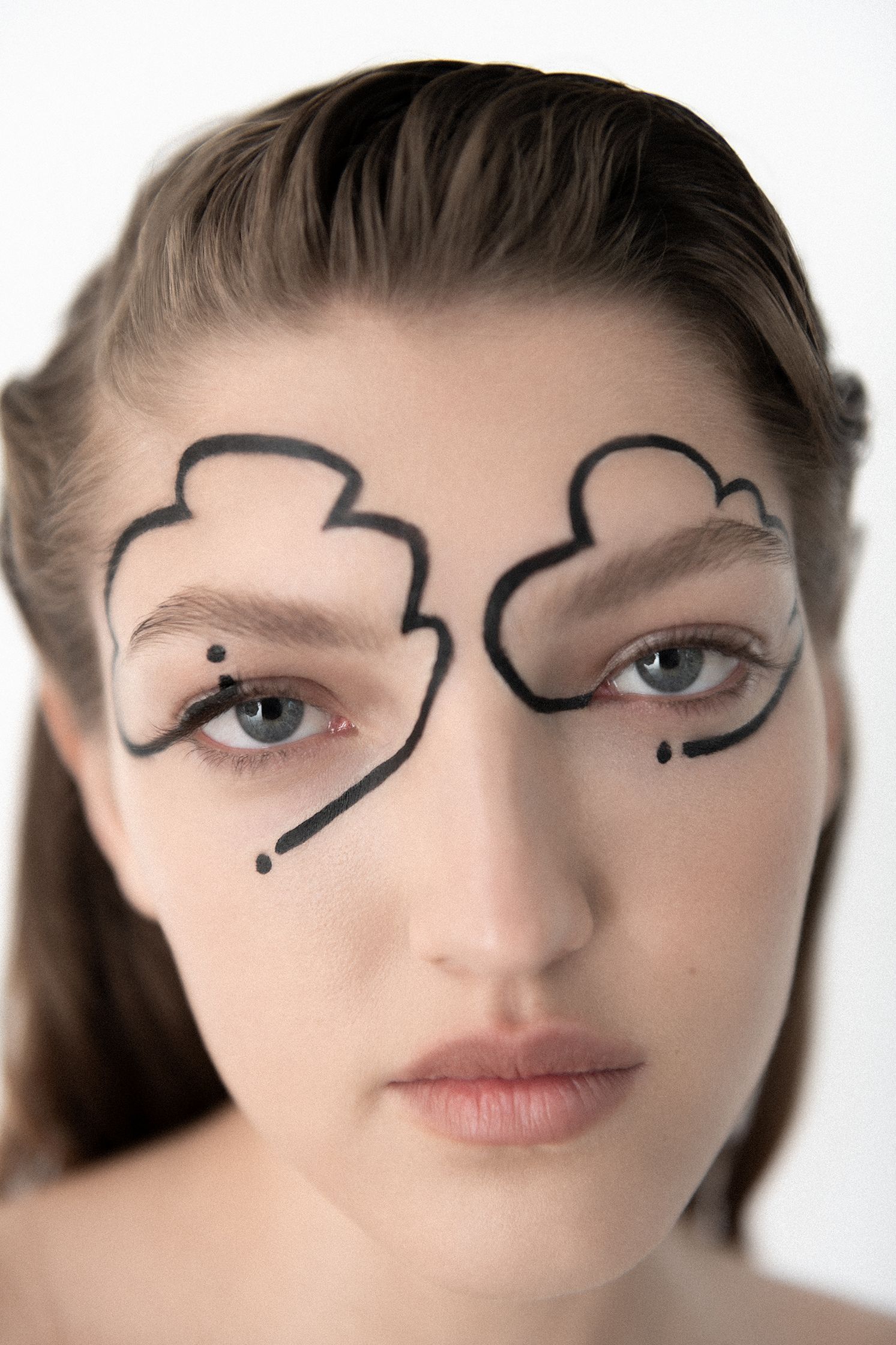 a woman with clouds painted on her face