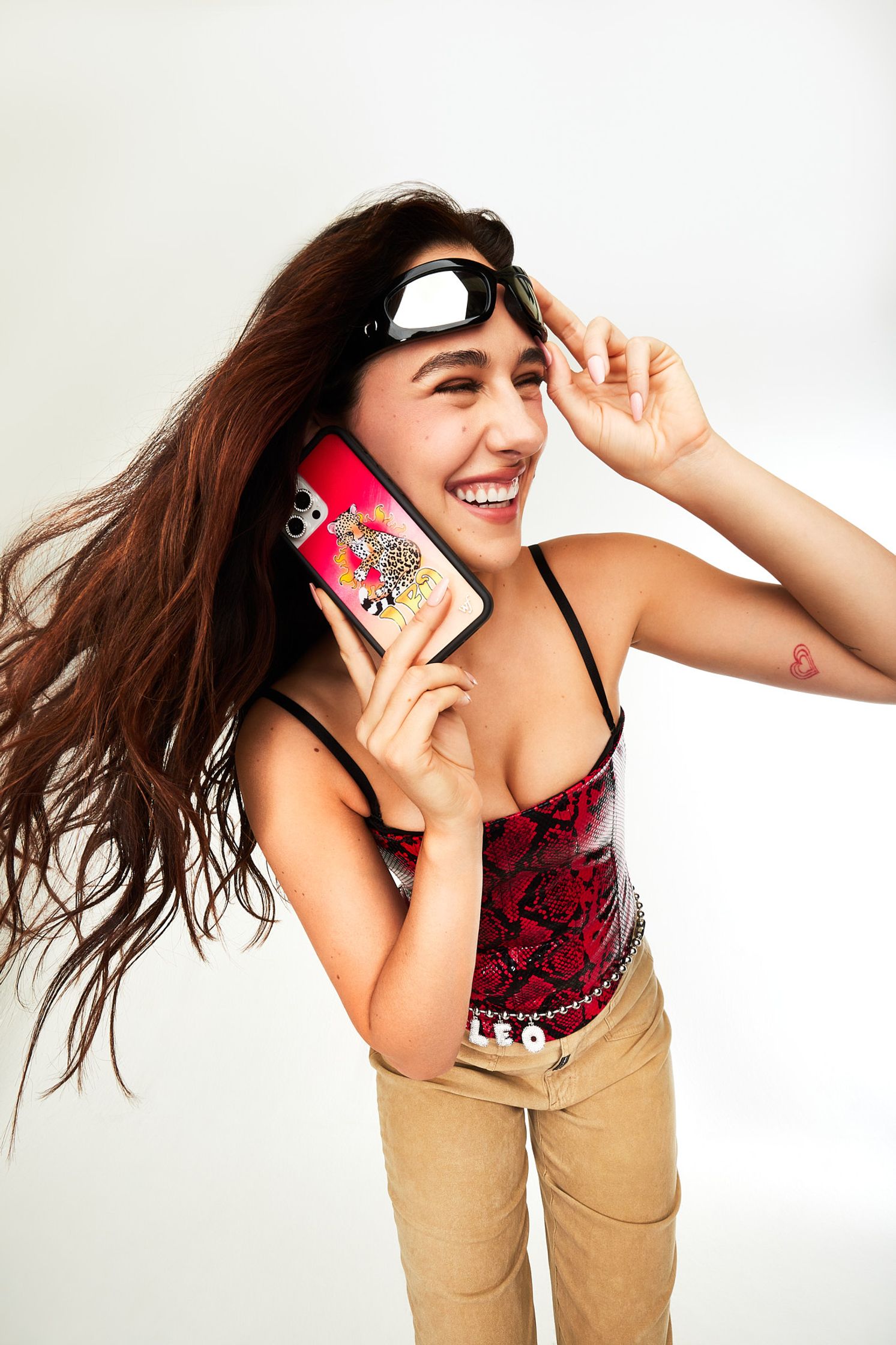 a woman with long hair holding a cell phone