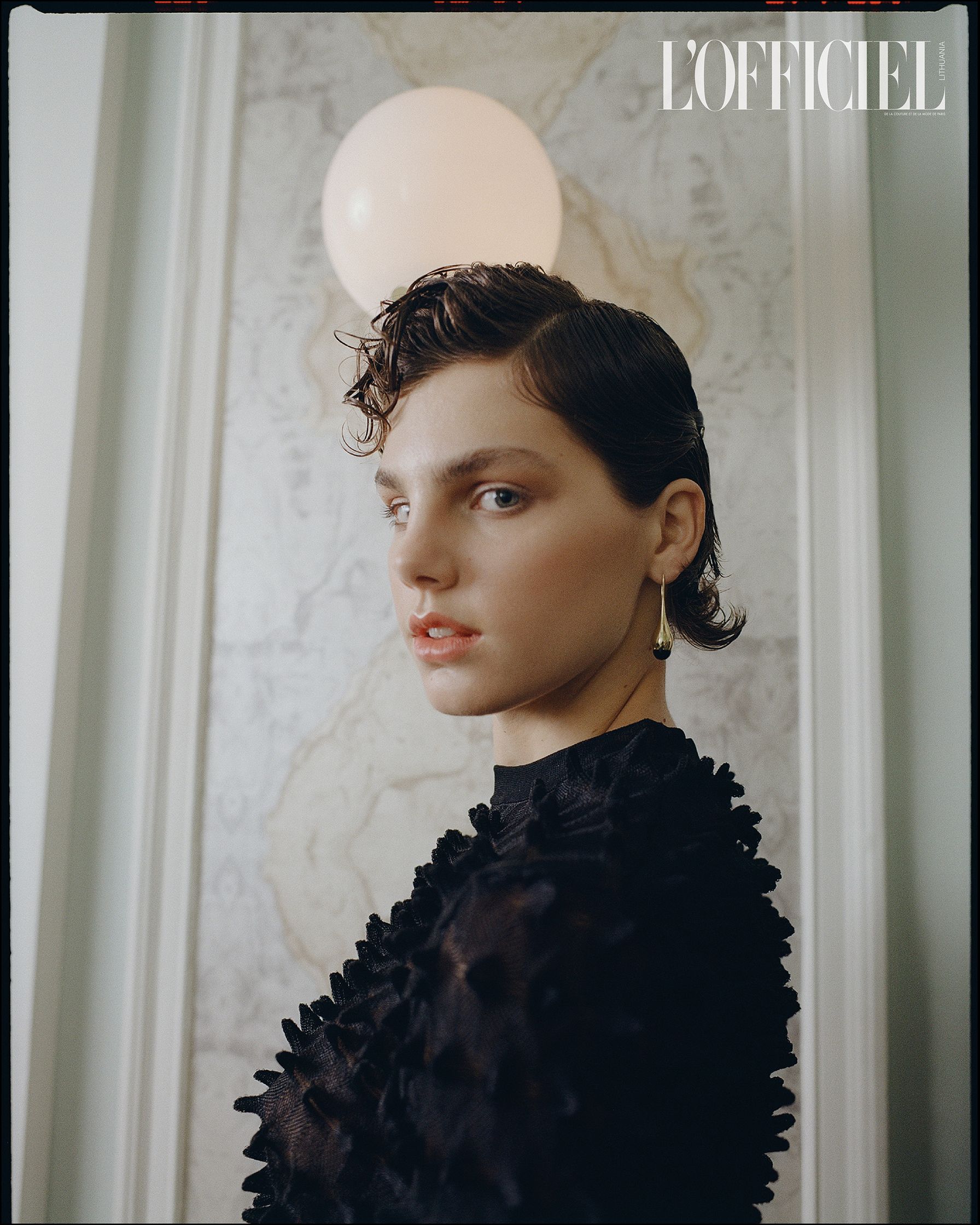 a woman in a black dress is posing in front of a mirror