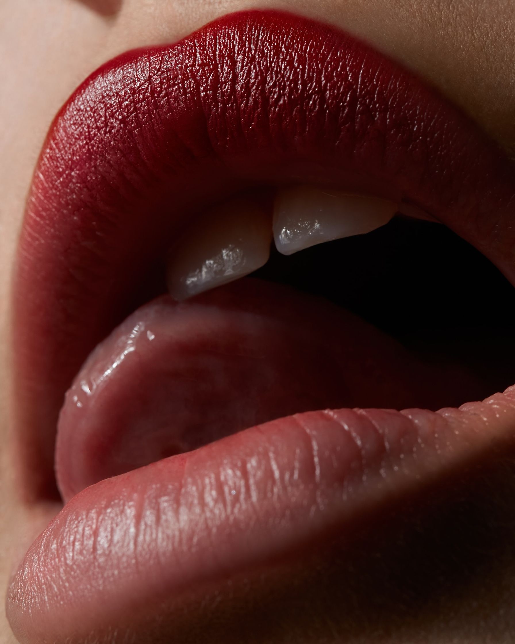 a close up of a woman's lips with red lipstick