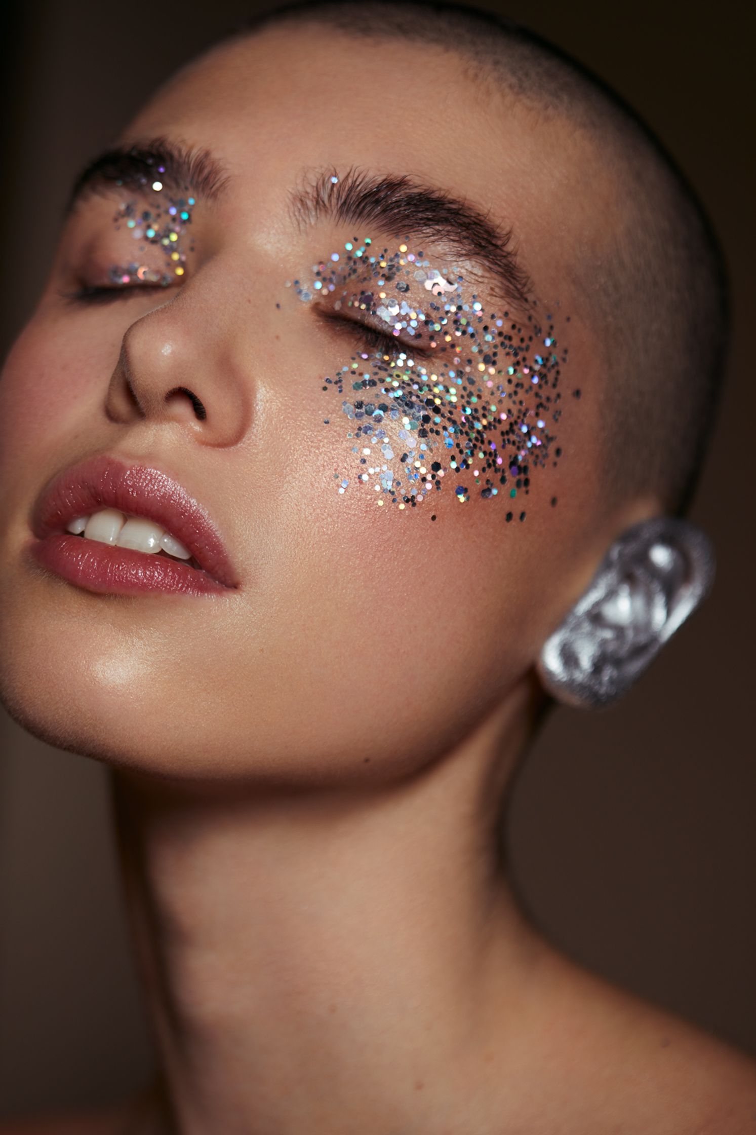 a woman with silver glitter on her face