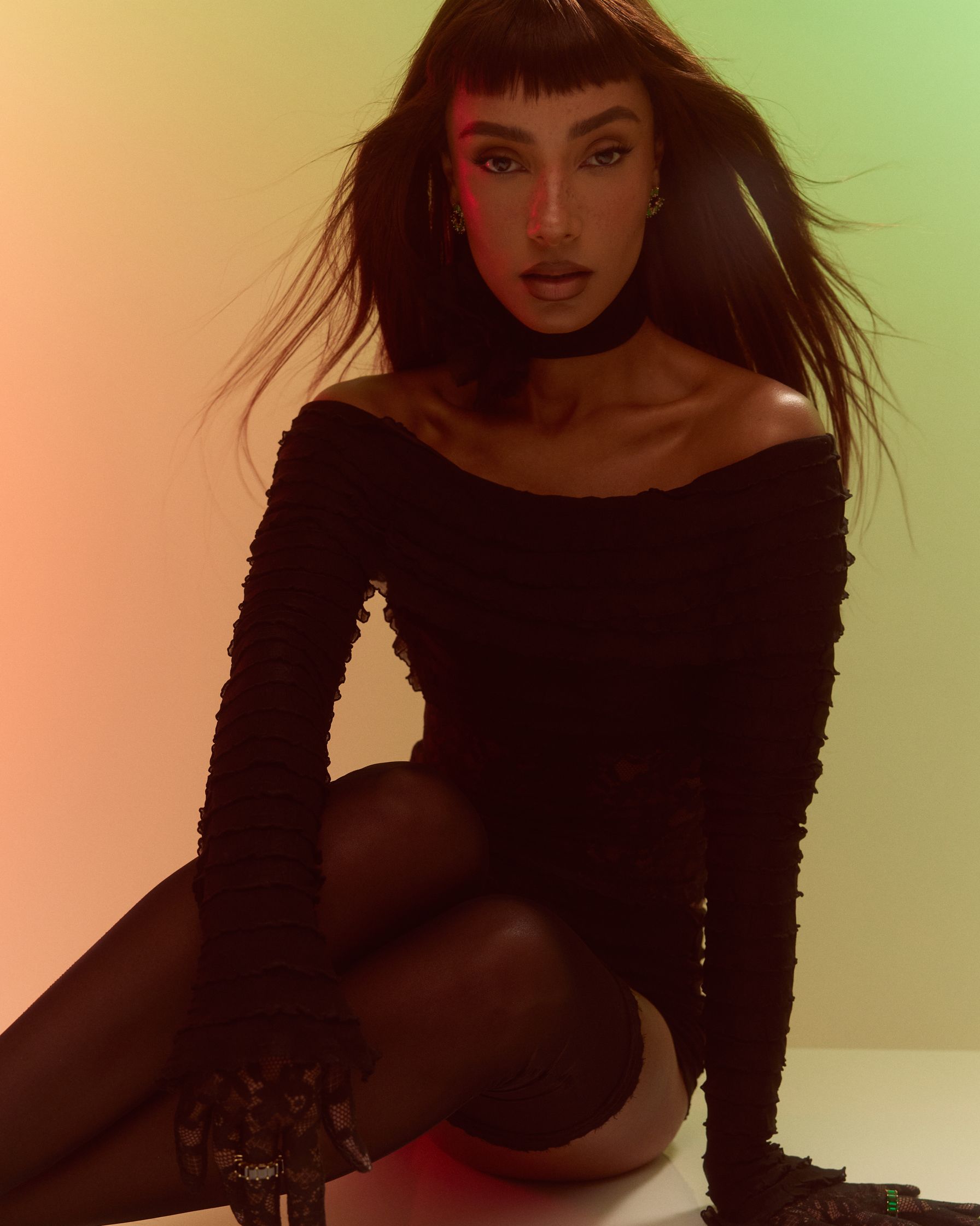 a woman in black stockings posing on a table
