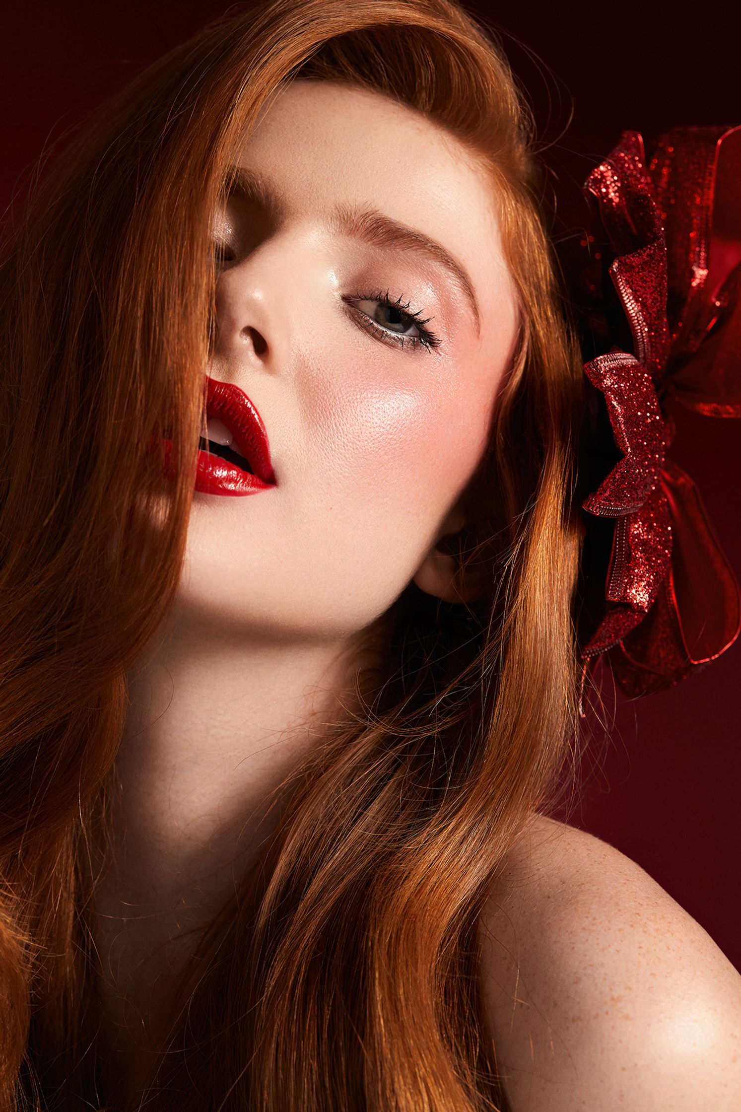 a woman with red hair and a red bow on her head