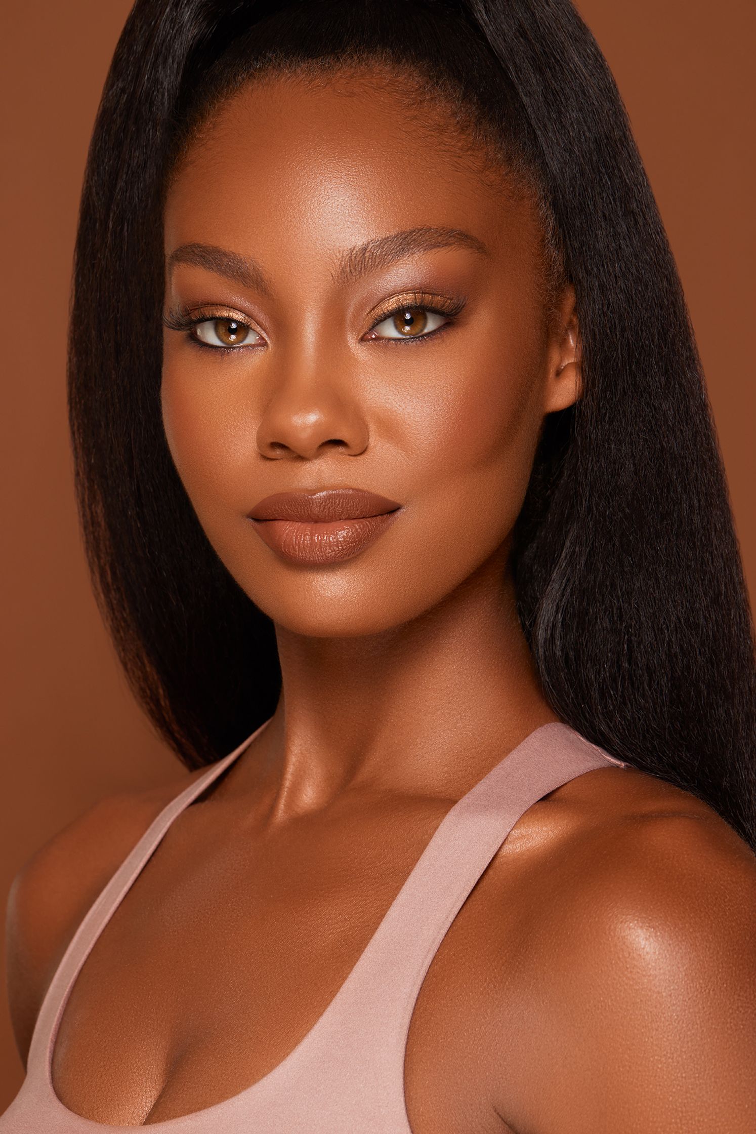 a black woman in a pink tank top posing for a photo