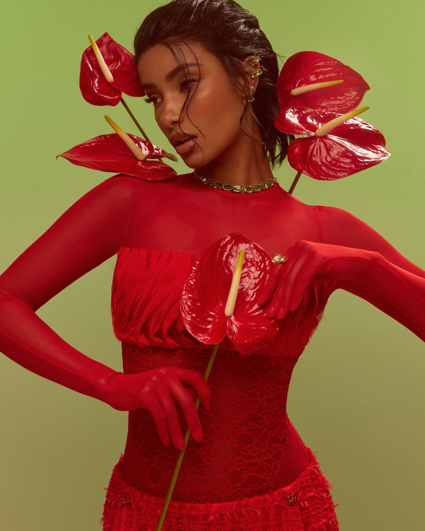 a woman in a red dress posing with flowers