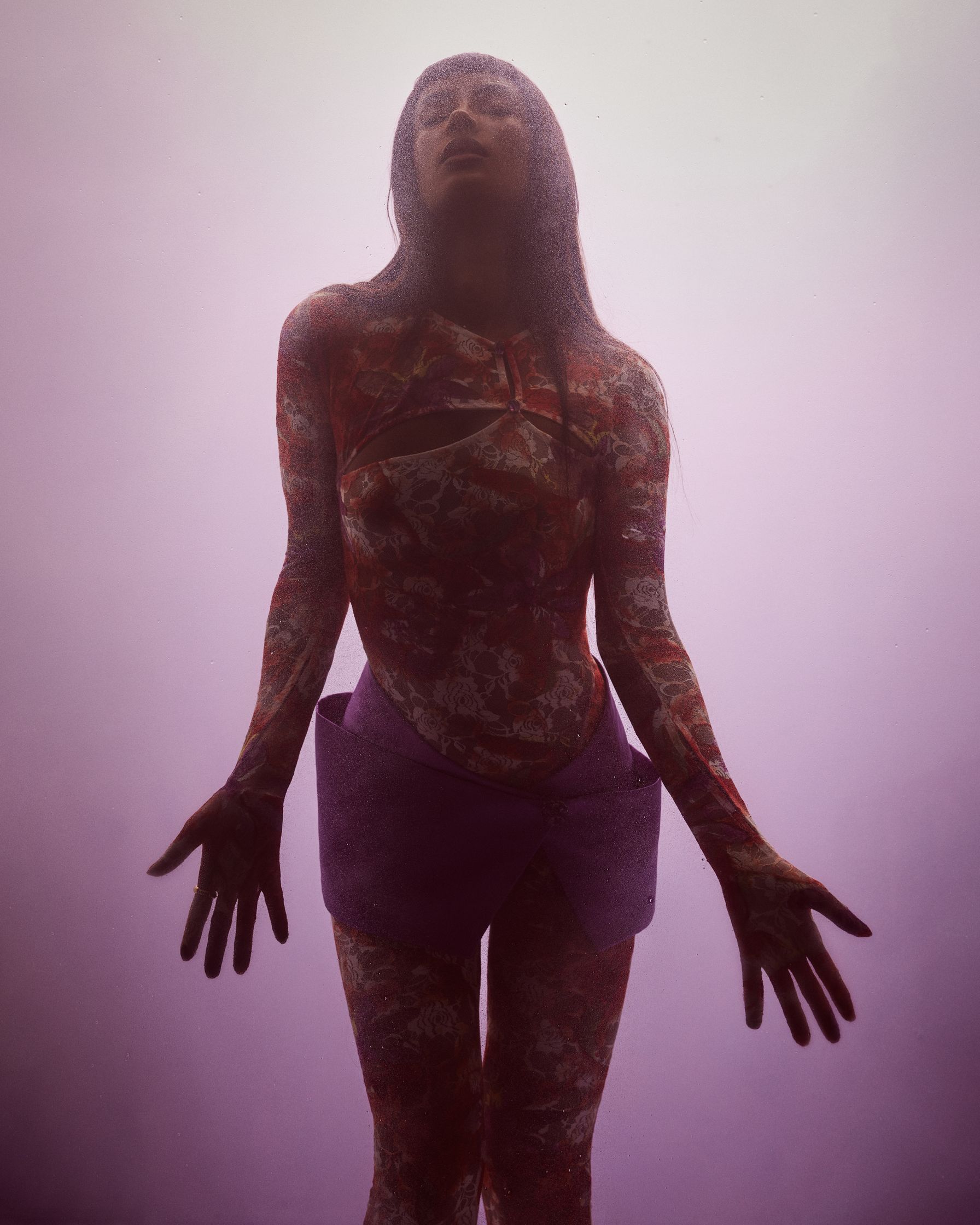 a woman in a purple dress standing in front of a fog