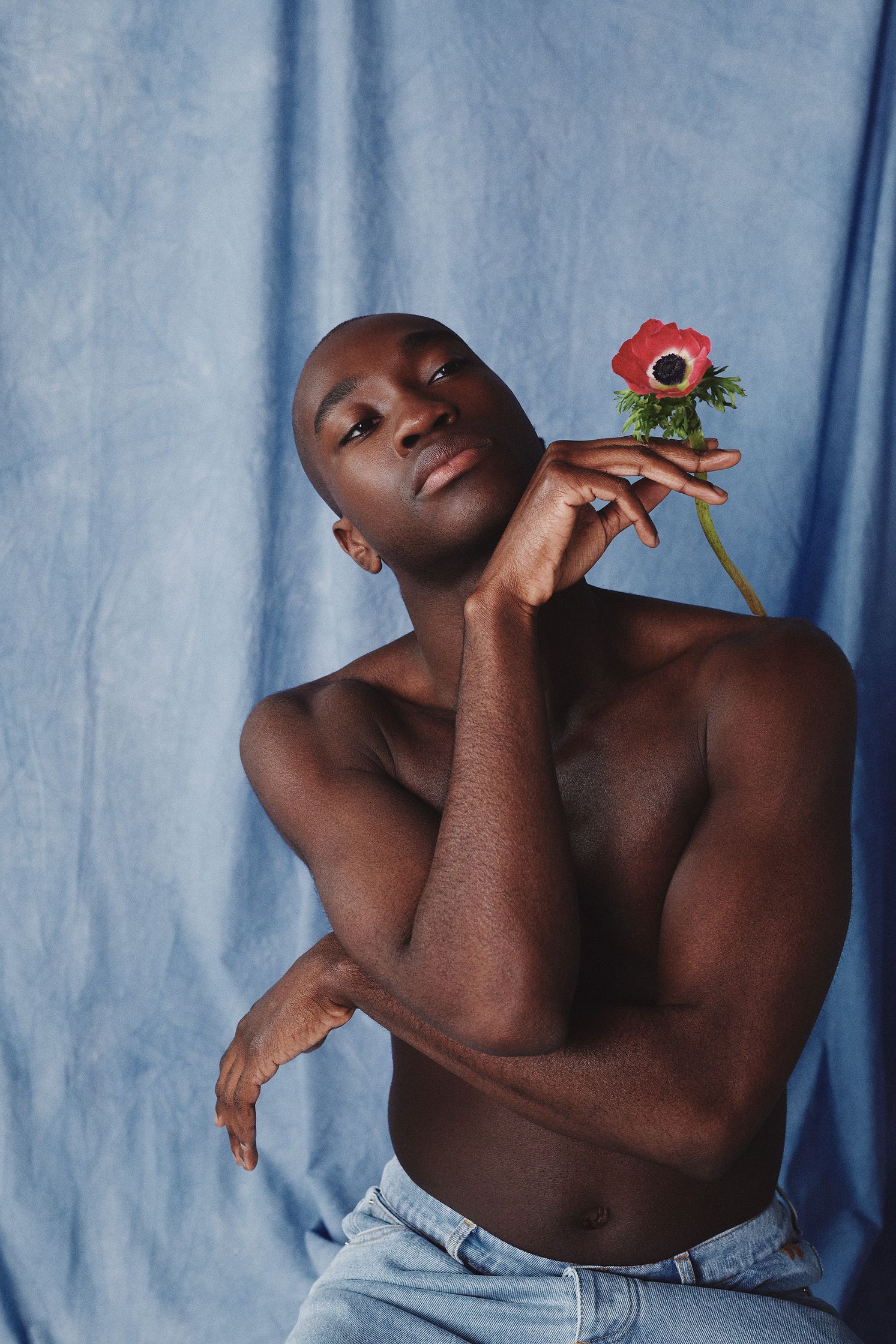 a black man holding a flower