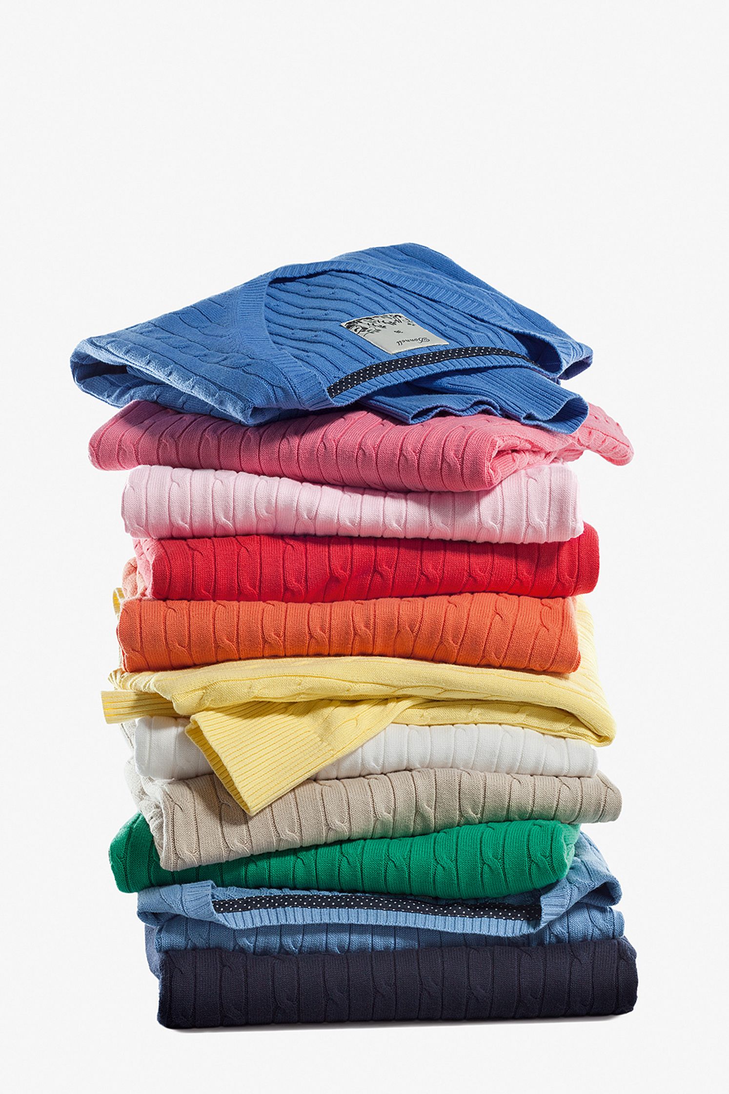 a stack of colorful t - shirts on a white background Post Production Hamburg