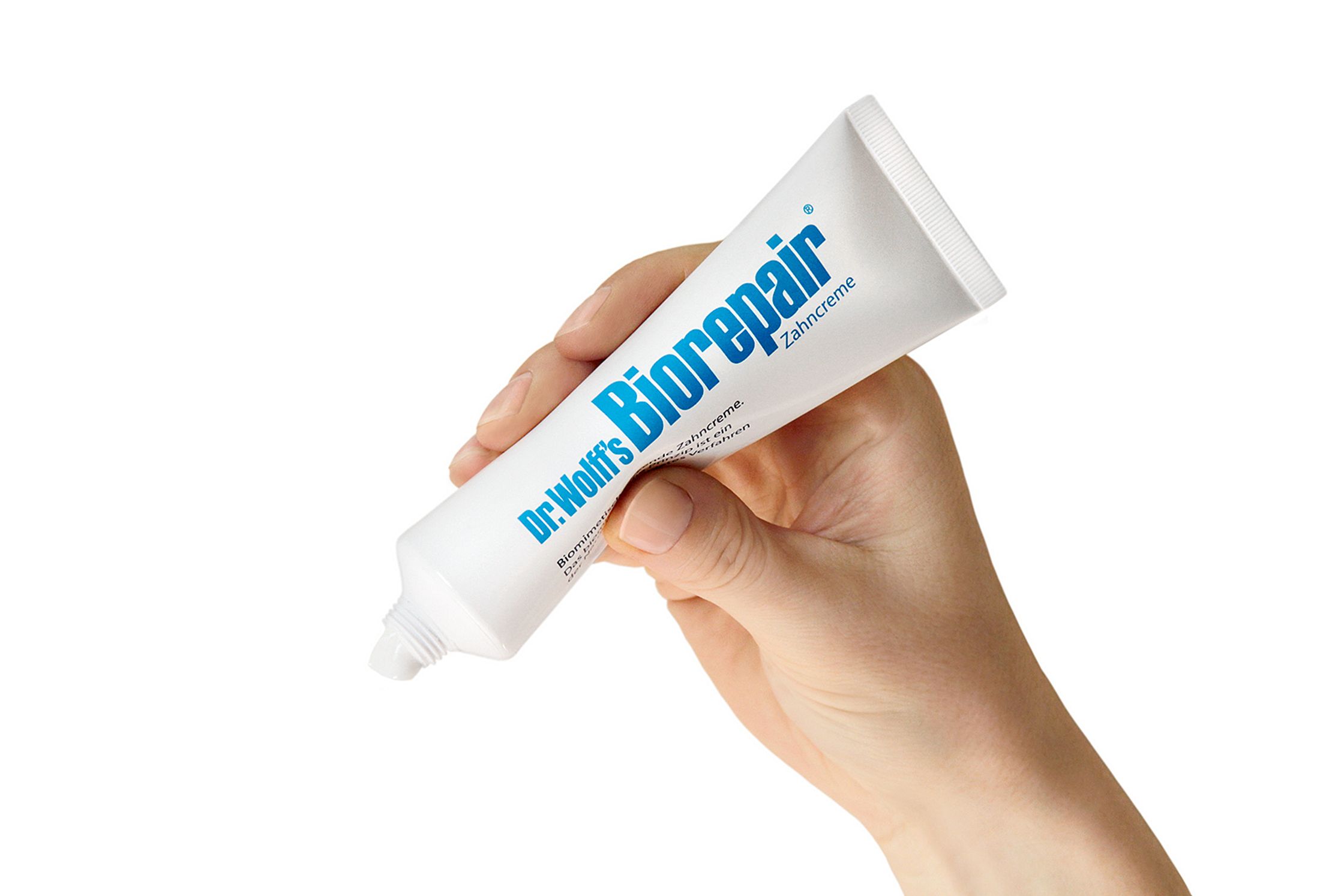 a hand holding a tube of biopair product Post Production - Retouch - Bildbearbeitung Hamburg