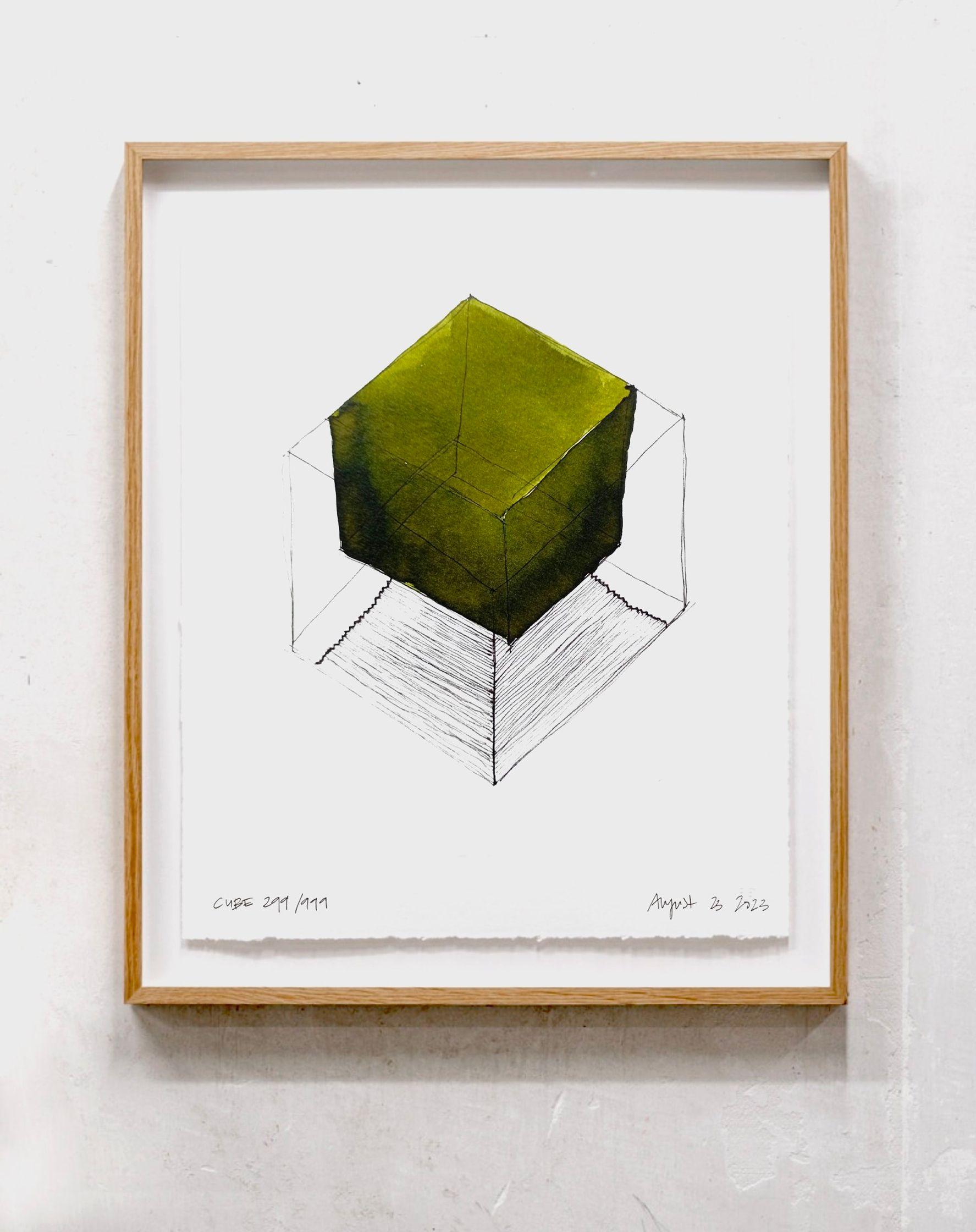 a drawing of a green cube hanging on a wall